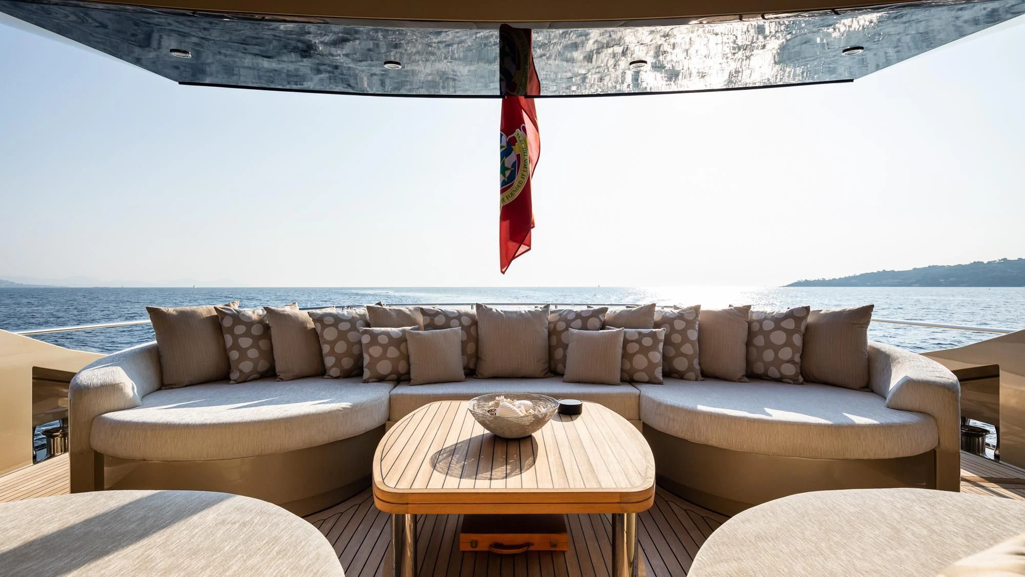 a couch with a table on it aboard HOKULANI Yacht for Sale