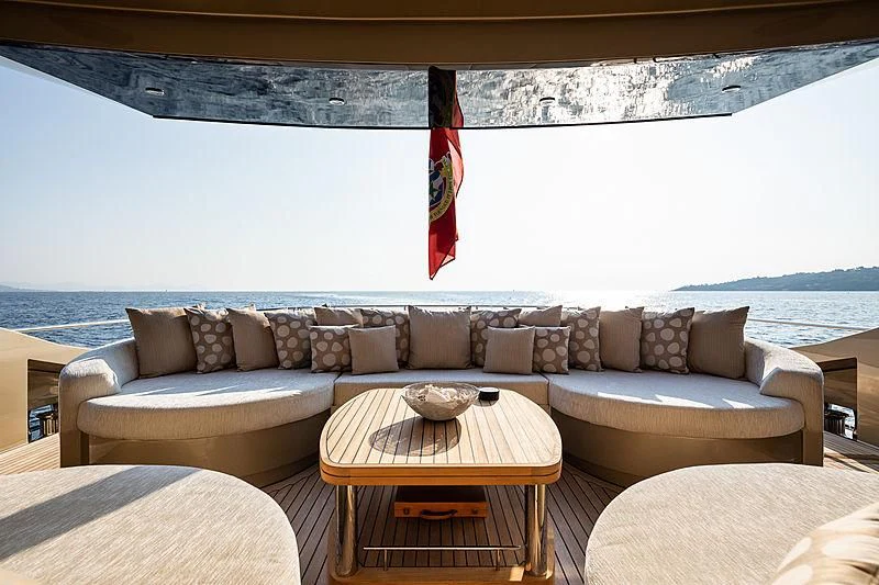 a couch with a table on it aboard HOKULANI Yacht for Sale