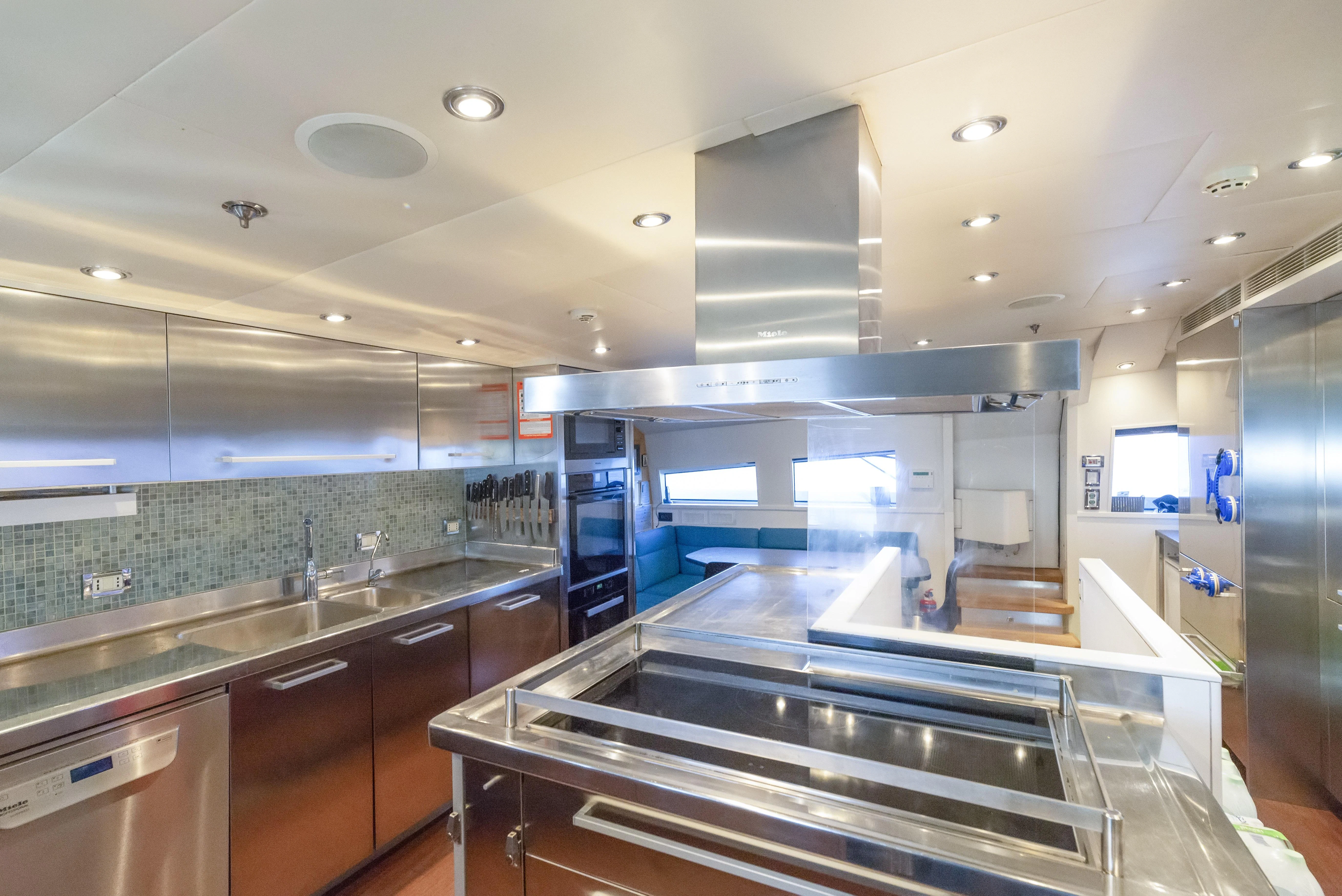 a kitchen with a large island aboard HOKULANI Yacht for Sale