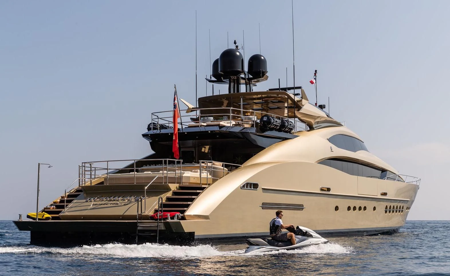 a large white boat with a couple people in it aboard HOKULANI Yacht for Sale