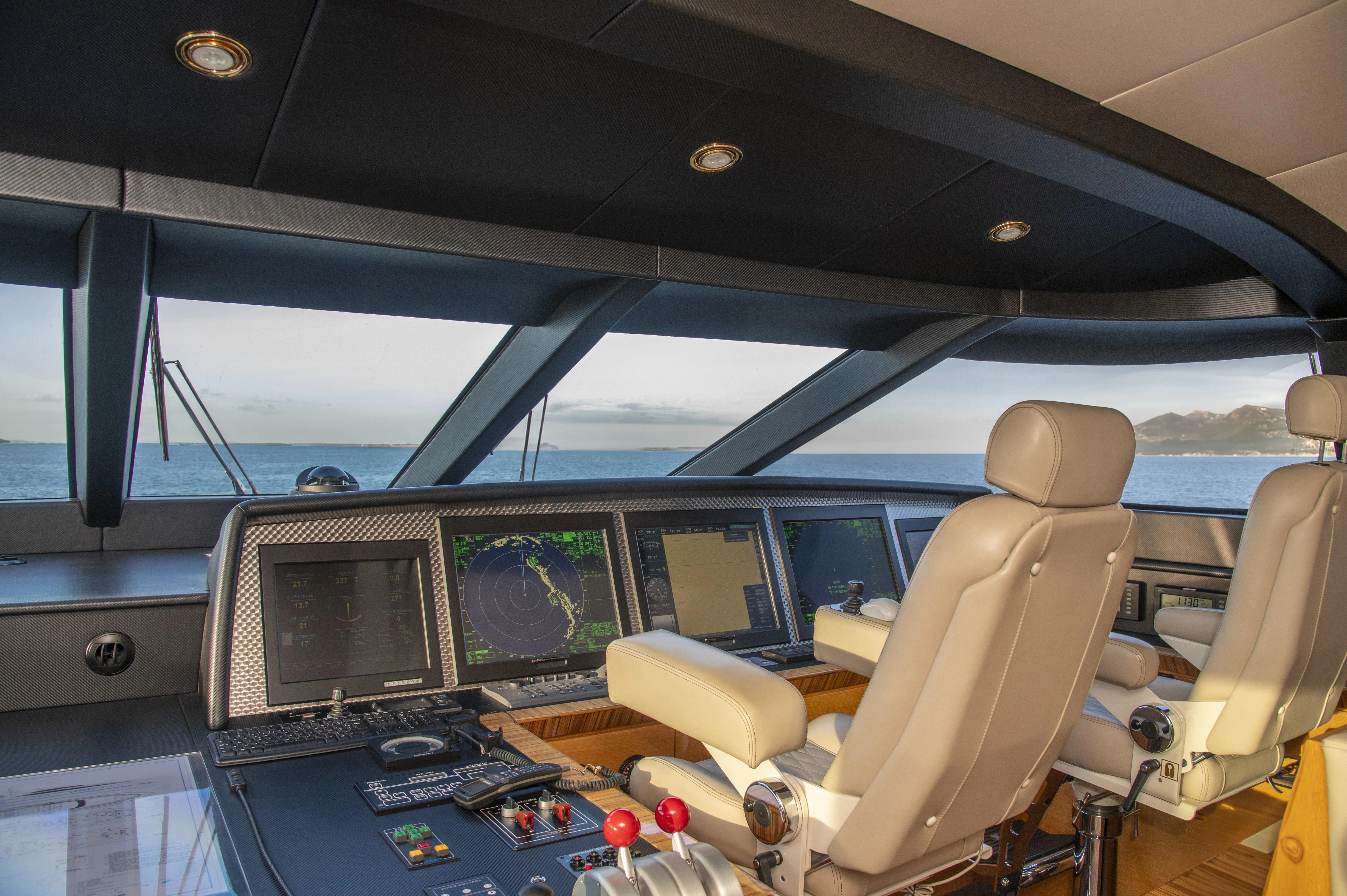 inside of a vehicle with a desk and computers aboard HOKULANI Yacht for Sale