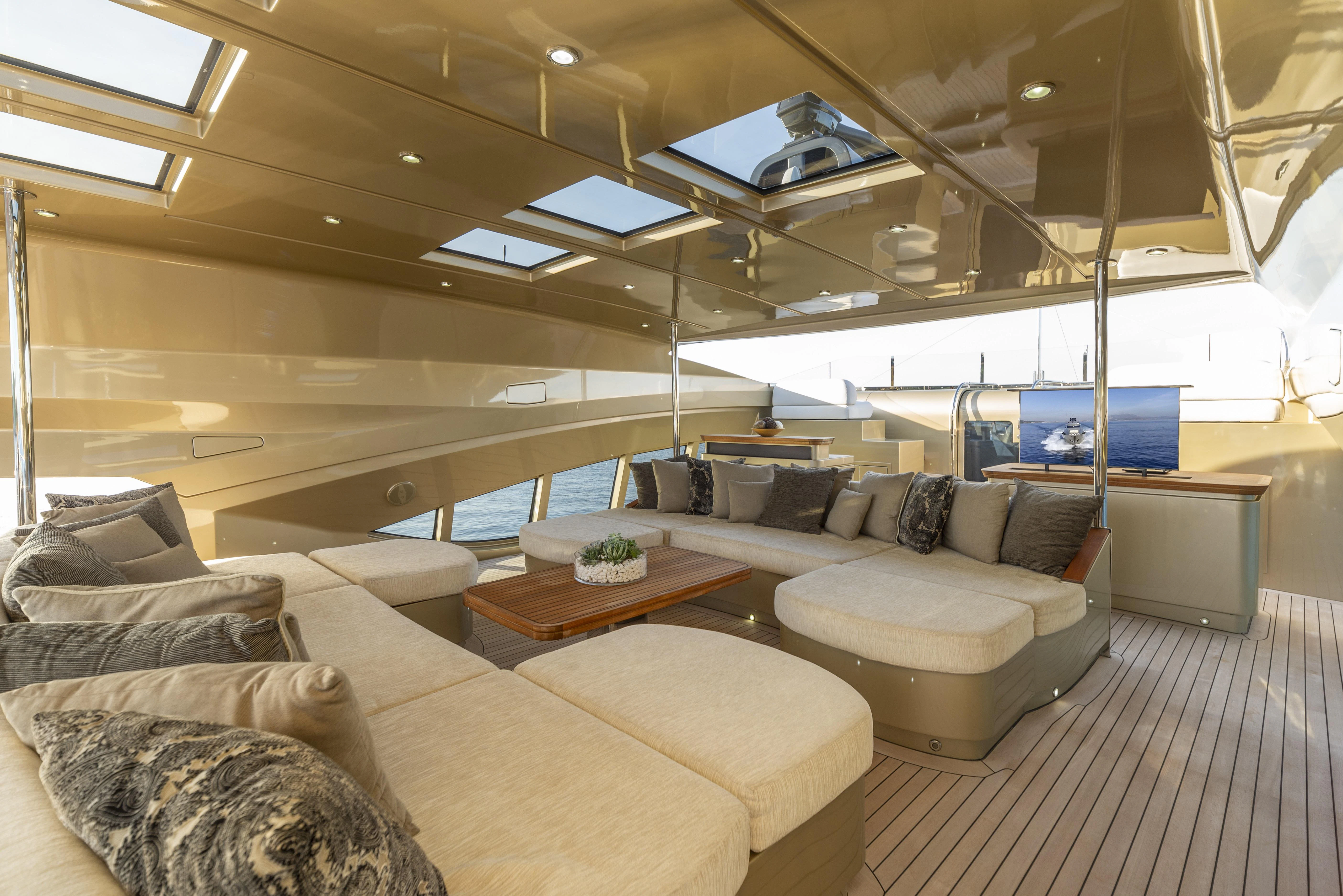 a large living room with a large sofa and a large window aboard HOKULANI Yacht for Sale