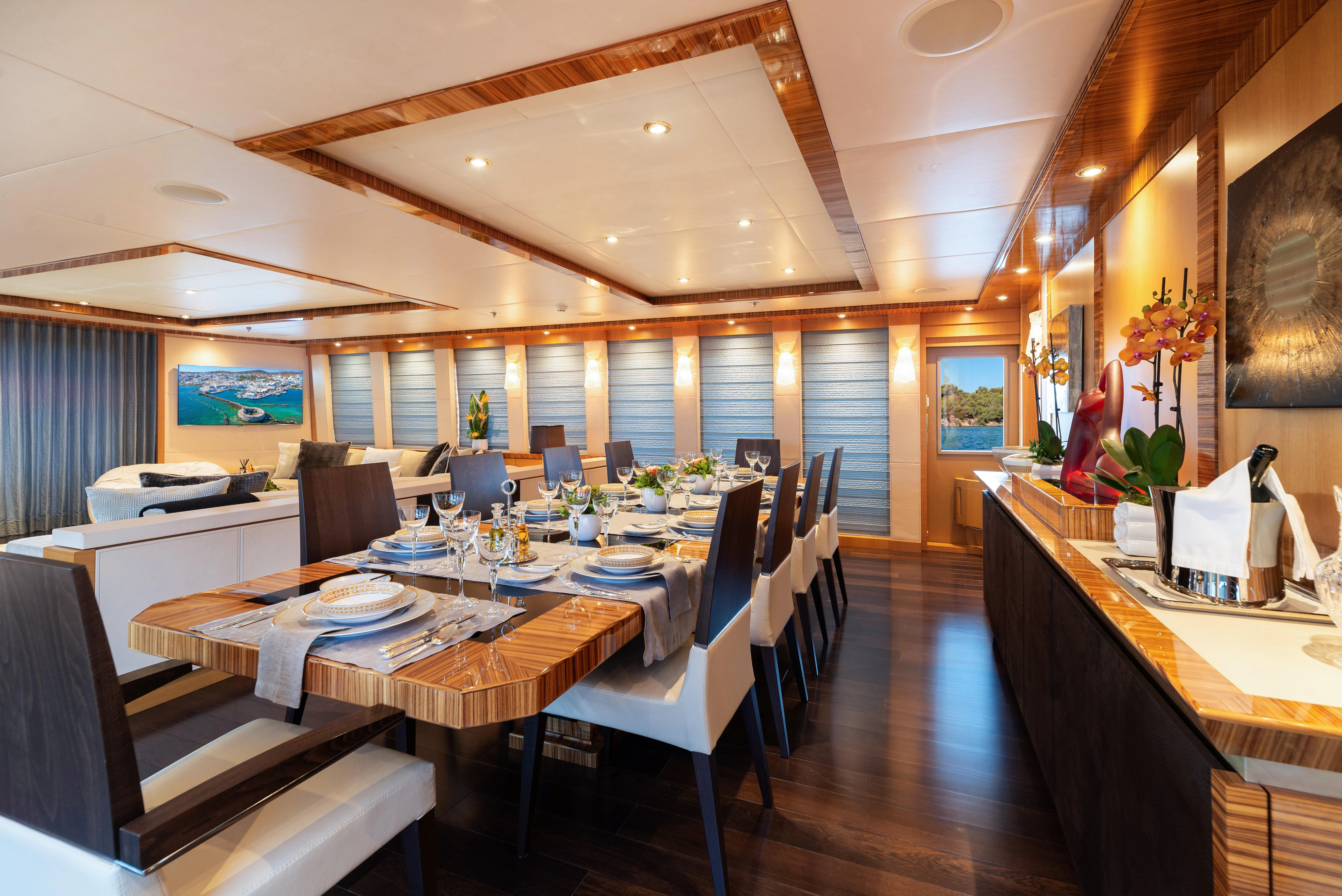 a restaurant with tables and chairs aboard HOKULANI Yacht for Sale