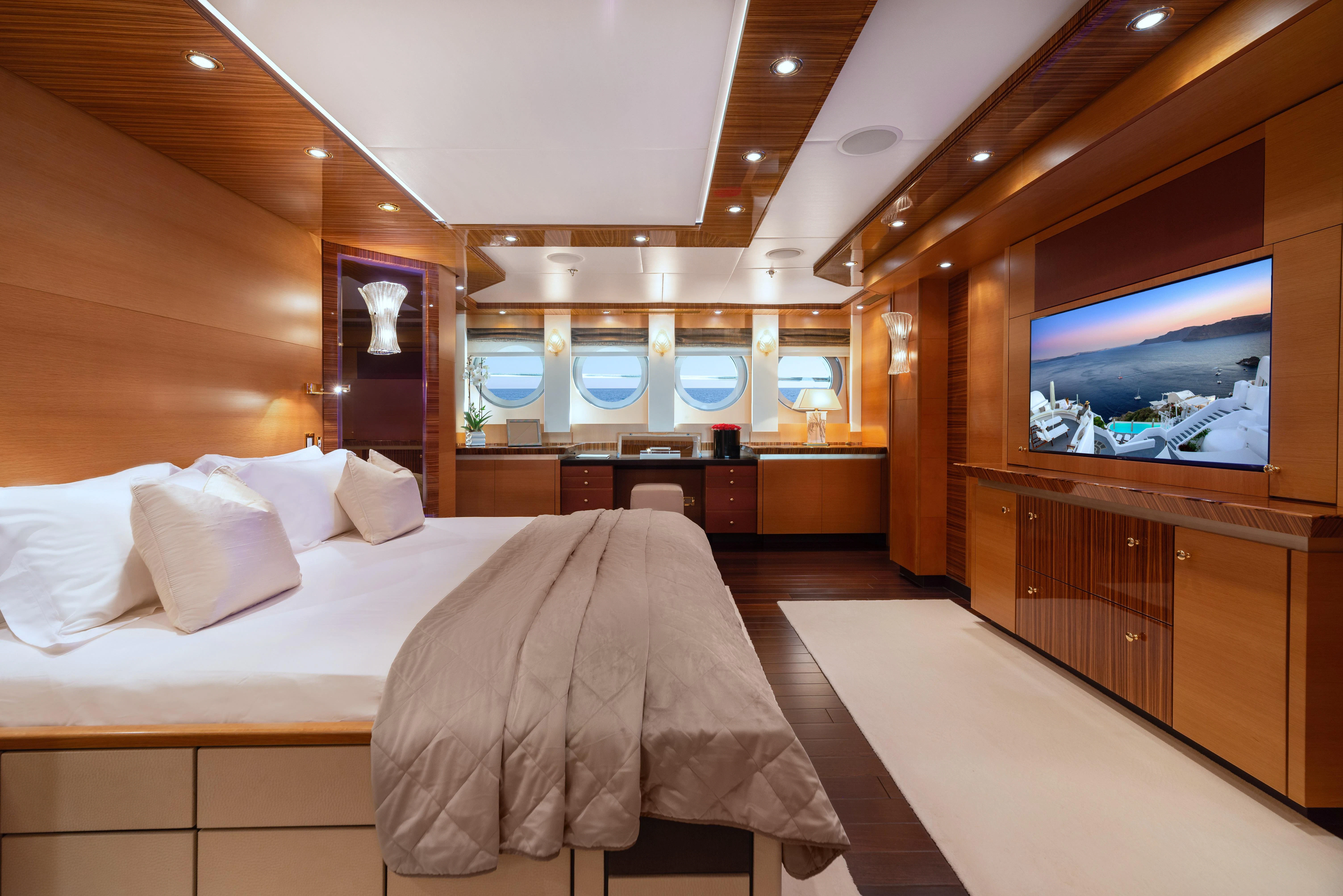 a room with a bed and a tv aboard HOKULANI Yacht for Sale