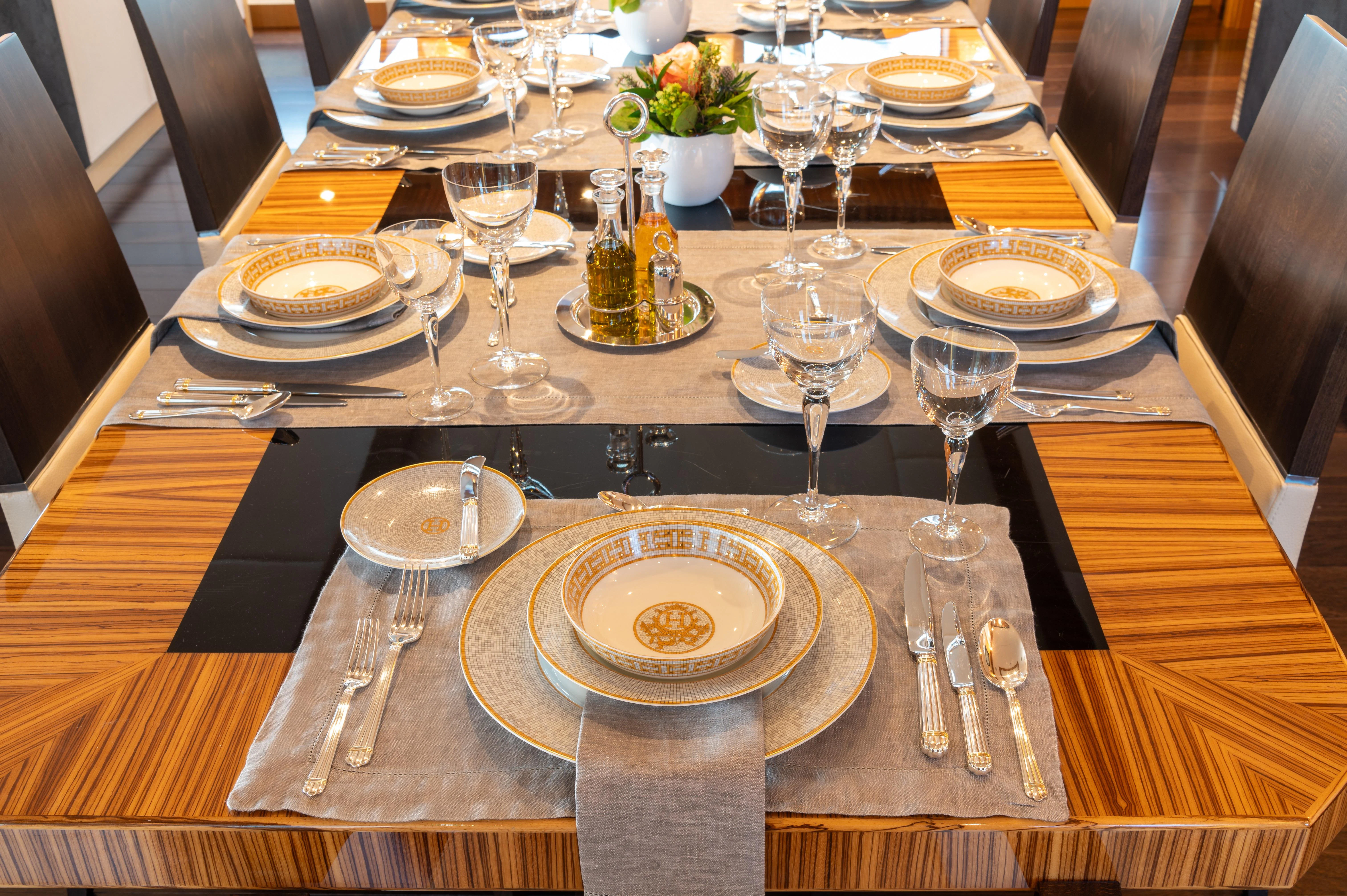 a table set with plates and silverware aboard HOKULANI Yacht for Sale
