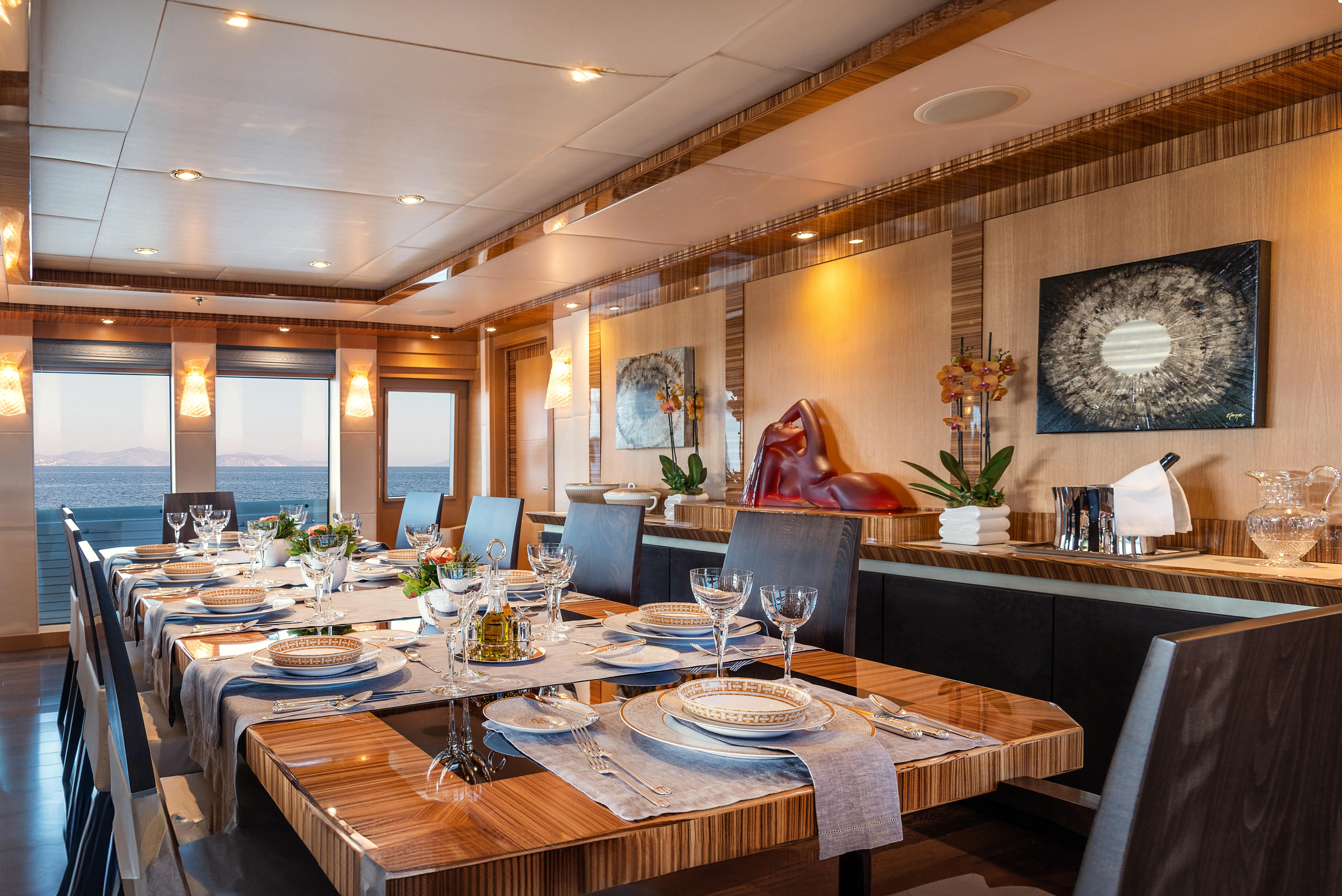 a large dining room with a table set for a meal aboard HOKULANI Yacht for Sale