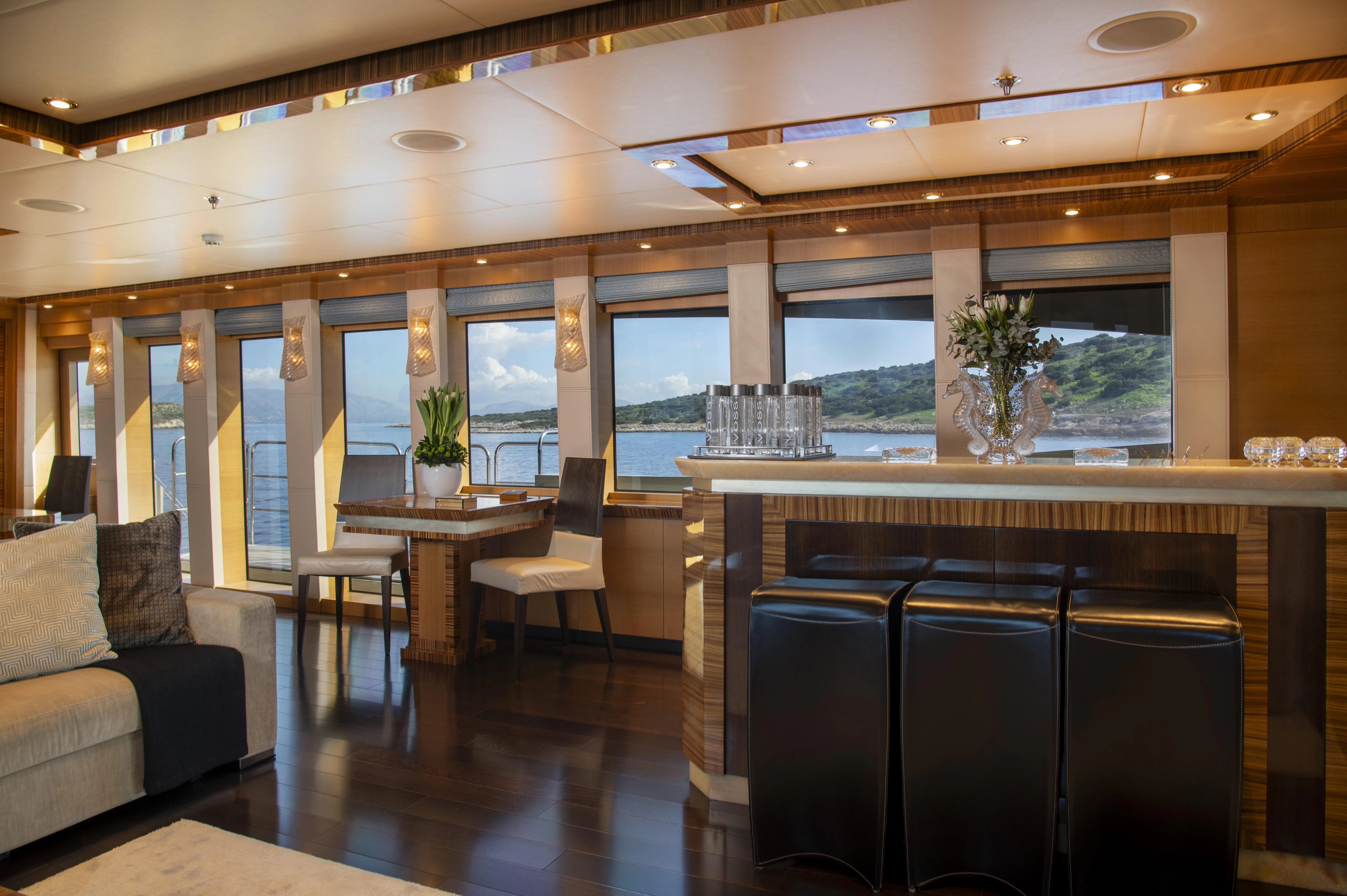 a room with a table and chairs aboard HOKULANI Yacht for Sale