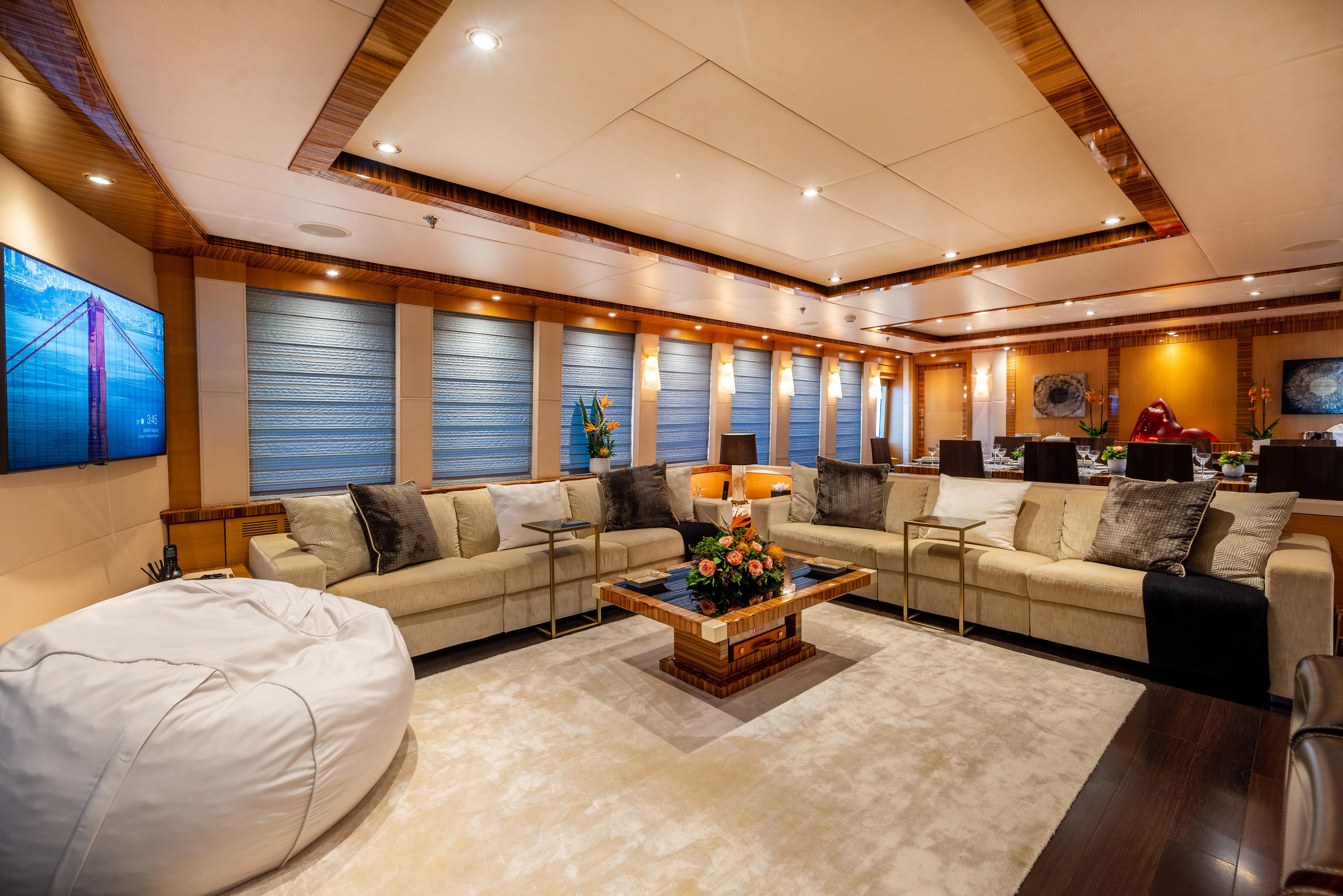 a large living room with a large bed and a large window aboard HOKULANI Yacht for Sale