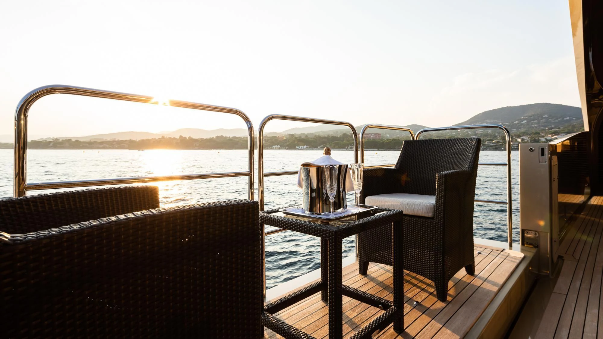 a table and chairs on a deck aboard HOKULANI Yacht for Sale