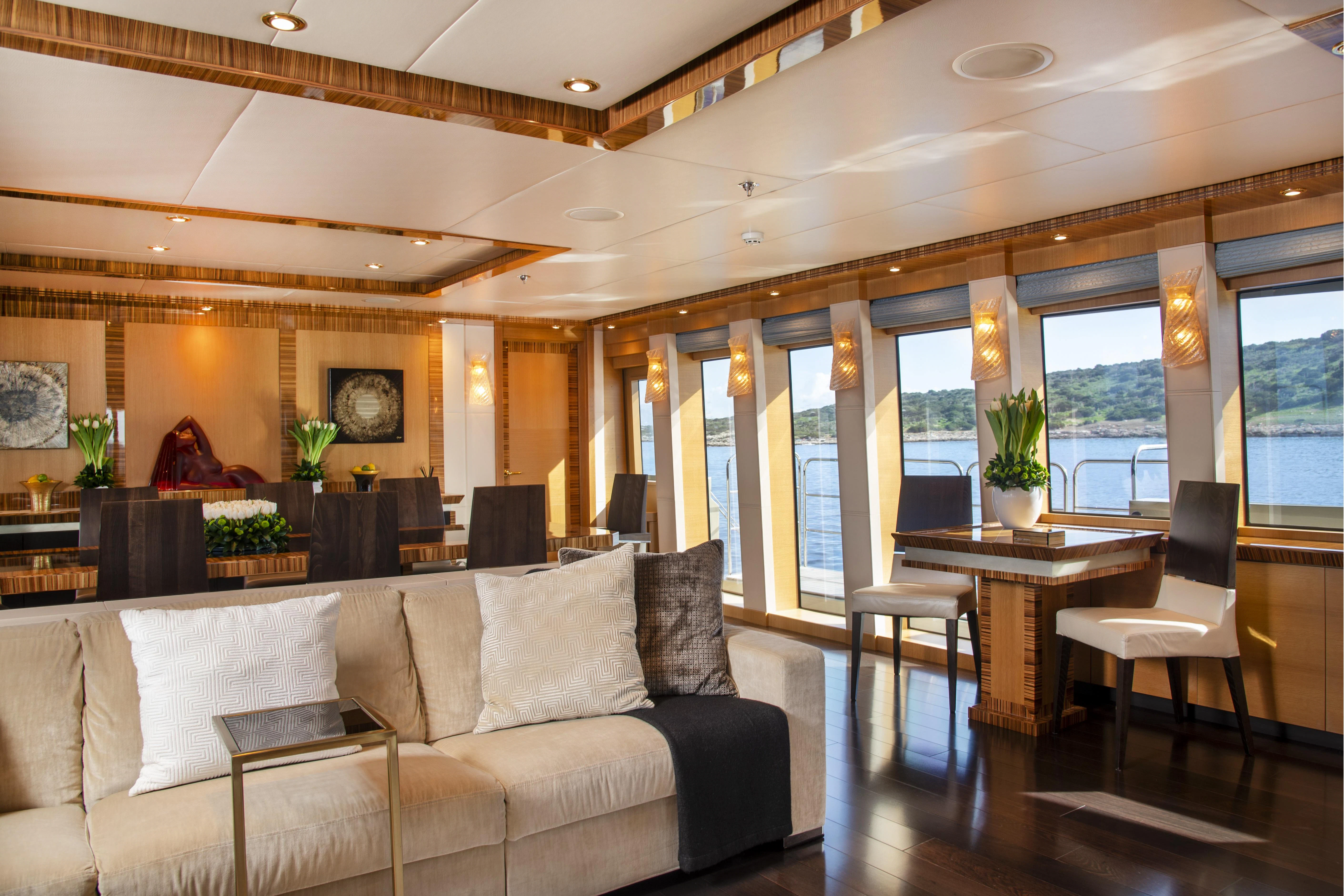 a living room with a couch and a table aboard HOKULANI Yacht for Sale