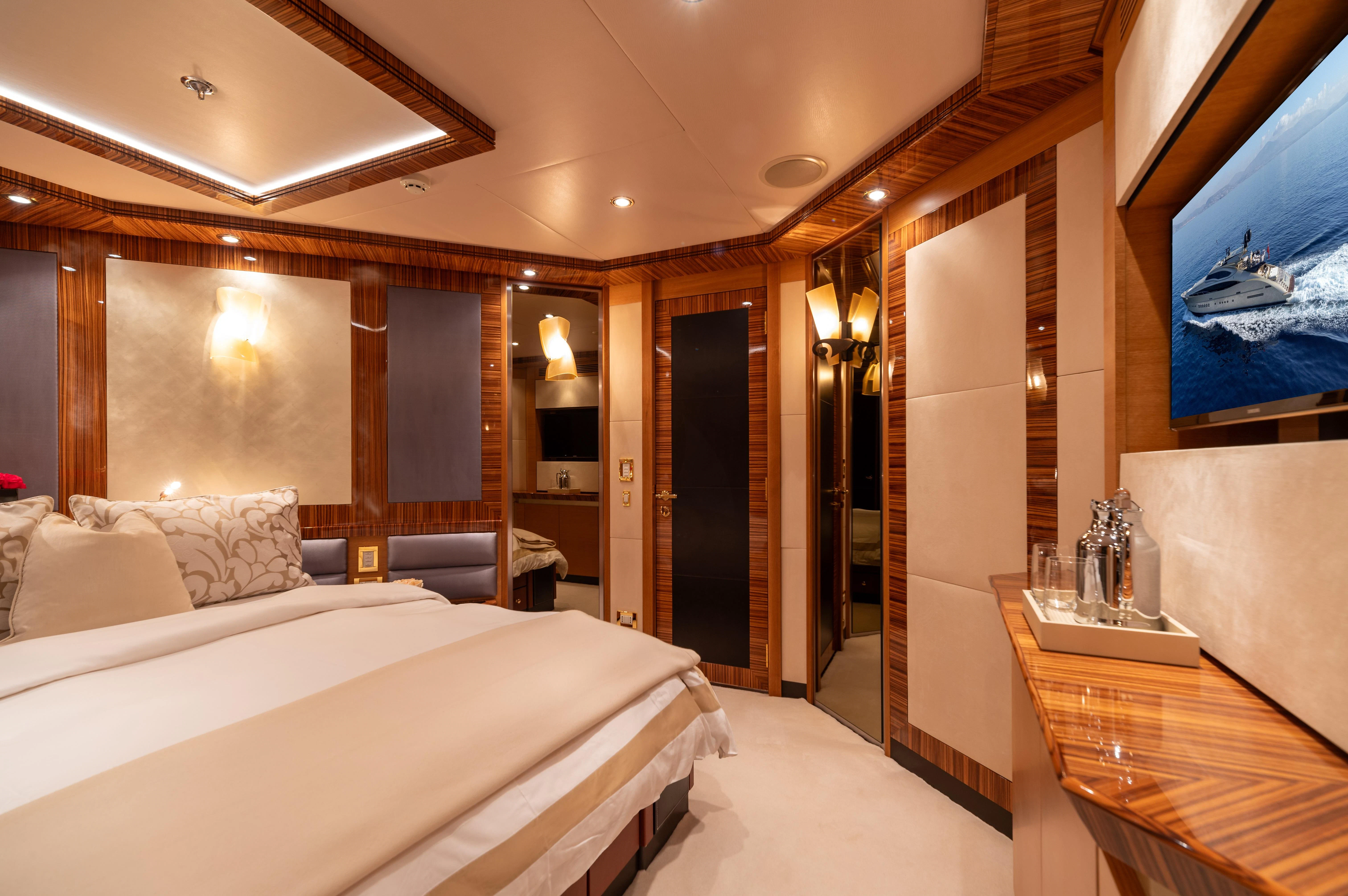 a room with a bed and a mirror aboard HOKULANI Yacht for Sale