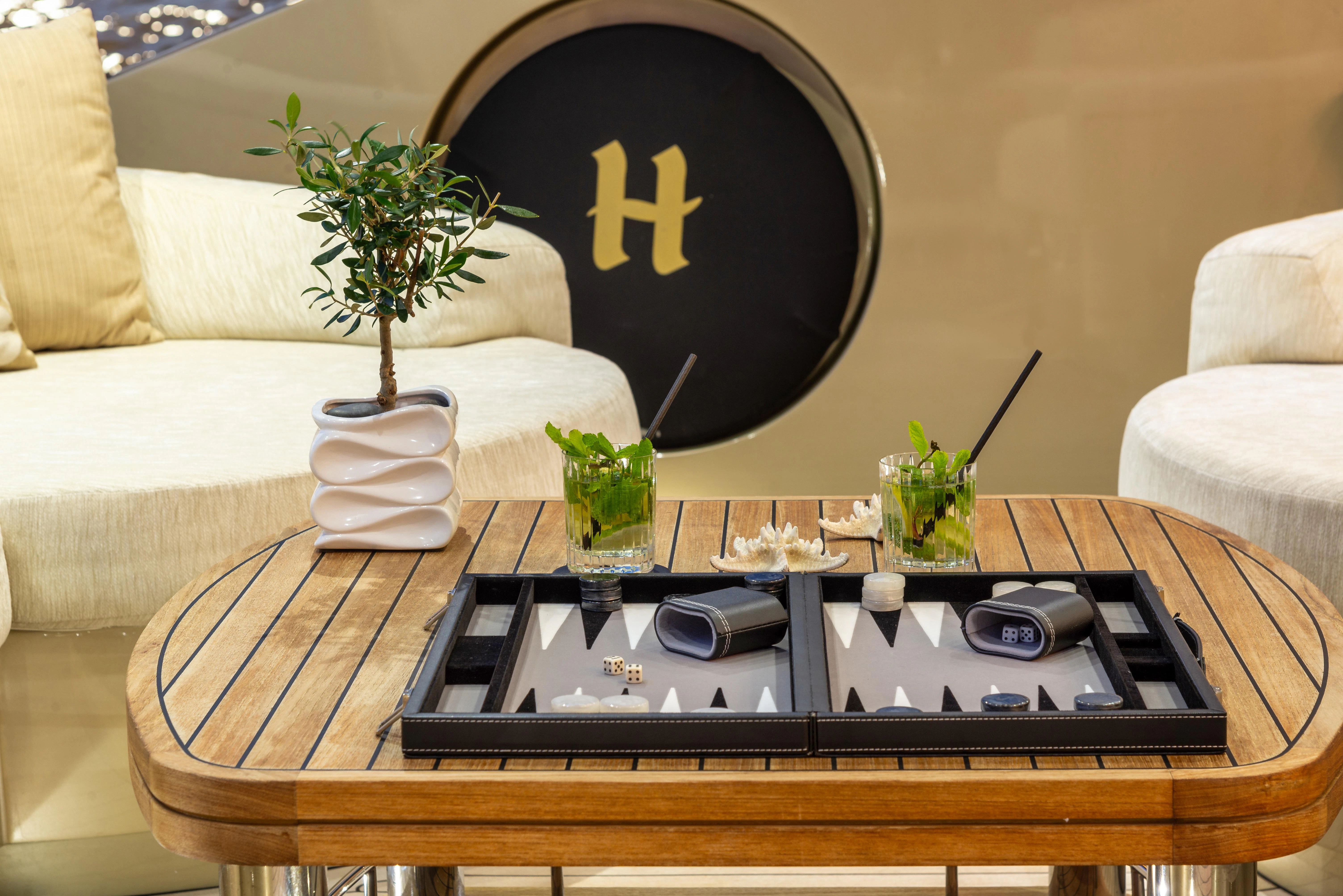a coffee table with a plant on it aboard HOKULANI Yacht for Sale
