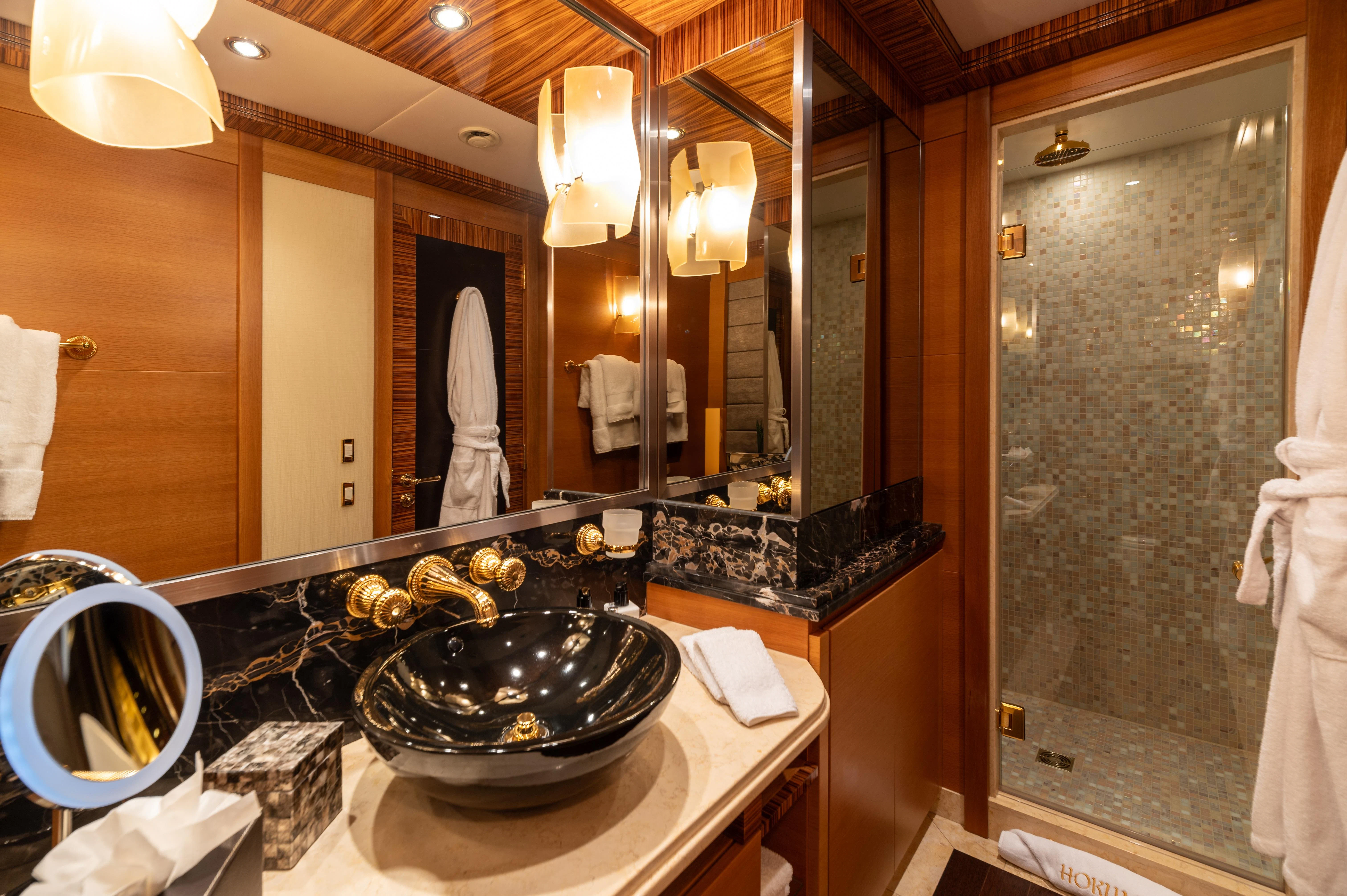 a bathroom with a large mirror aboard HOKULANI Yacht for Sale