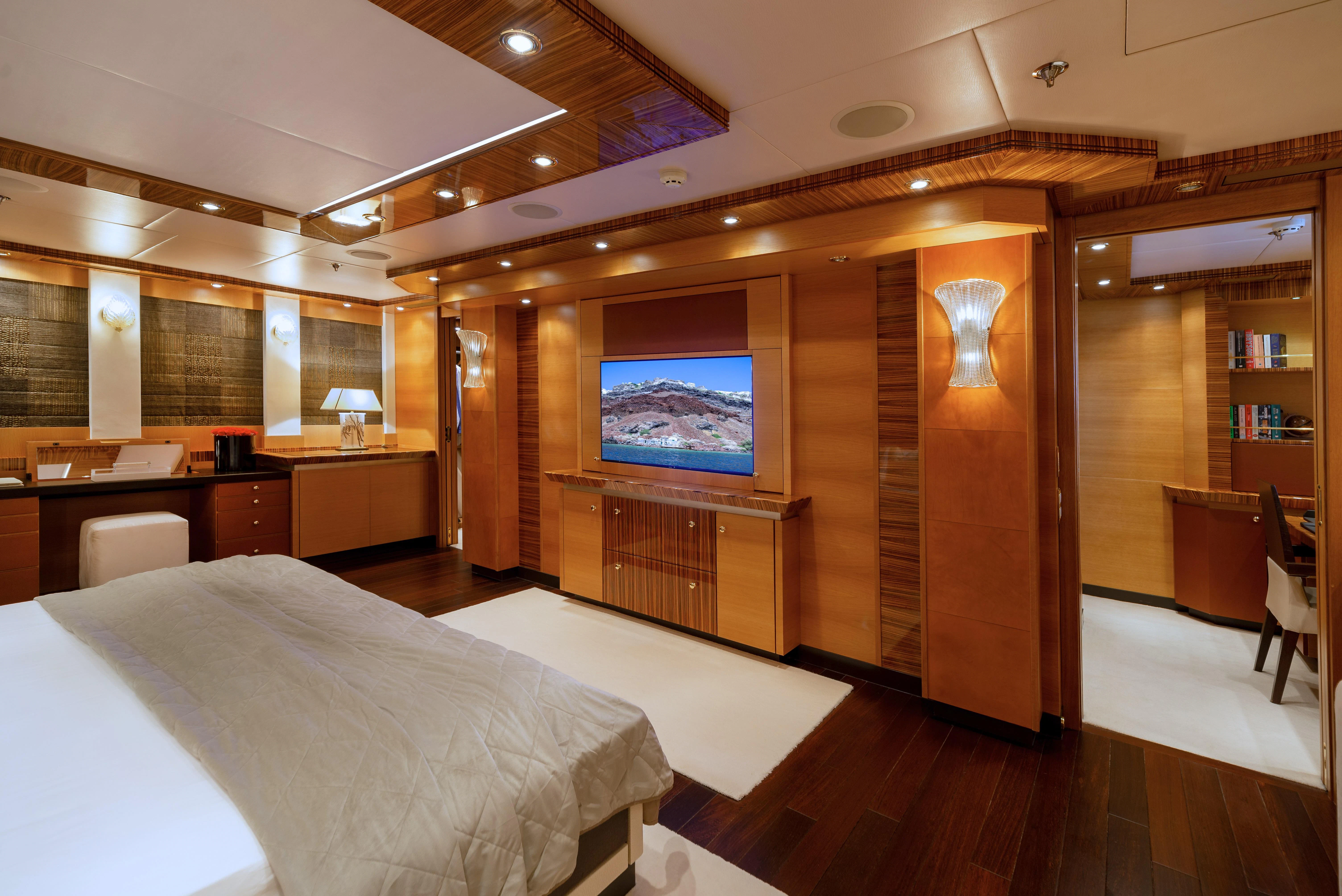 a room with a bed and a tv aboard HOKULANI Yacht for Sale