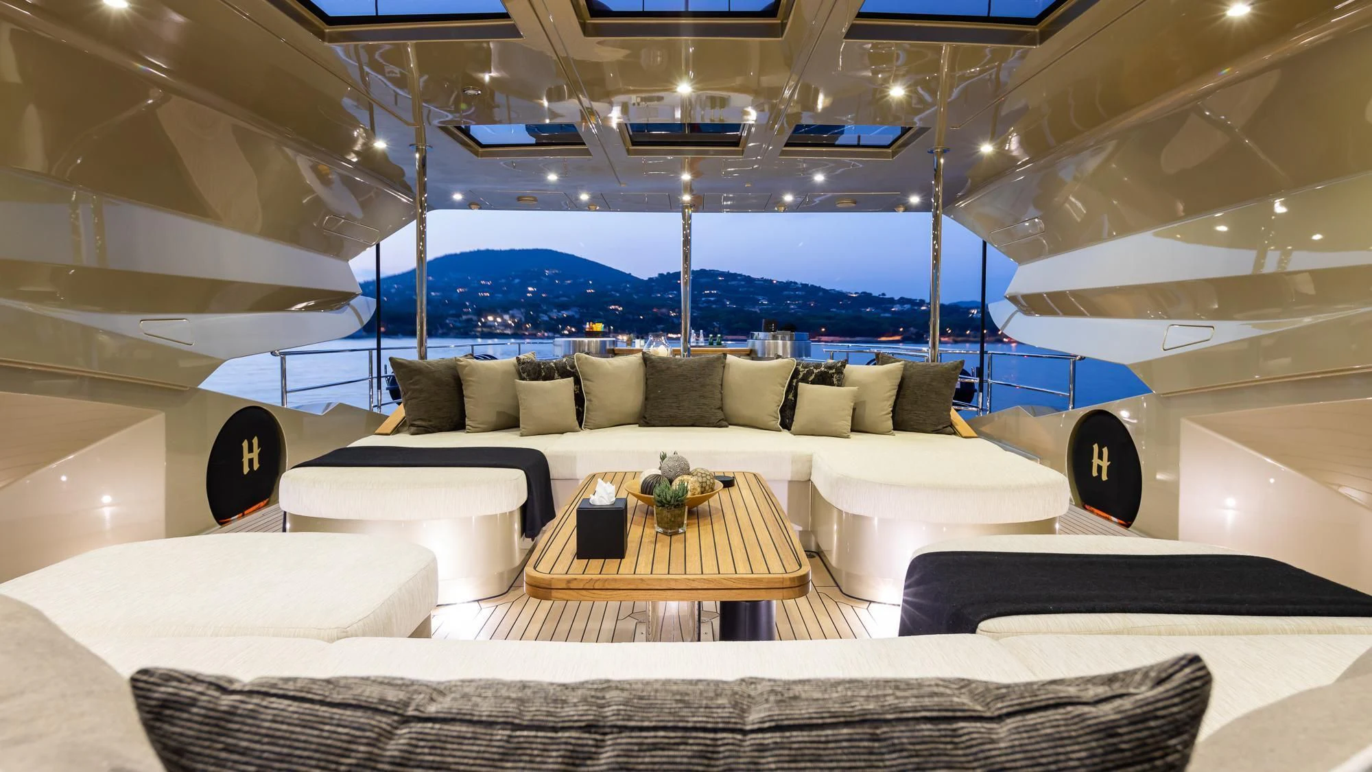 a living room with a large white couch and a large window aboard HOKULANI Yacht for Sale