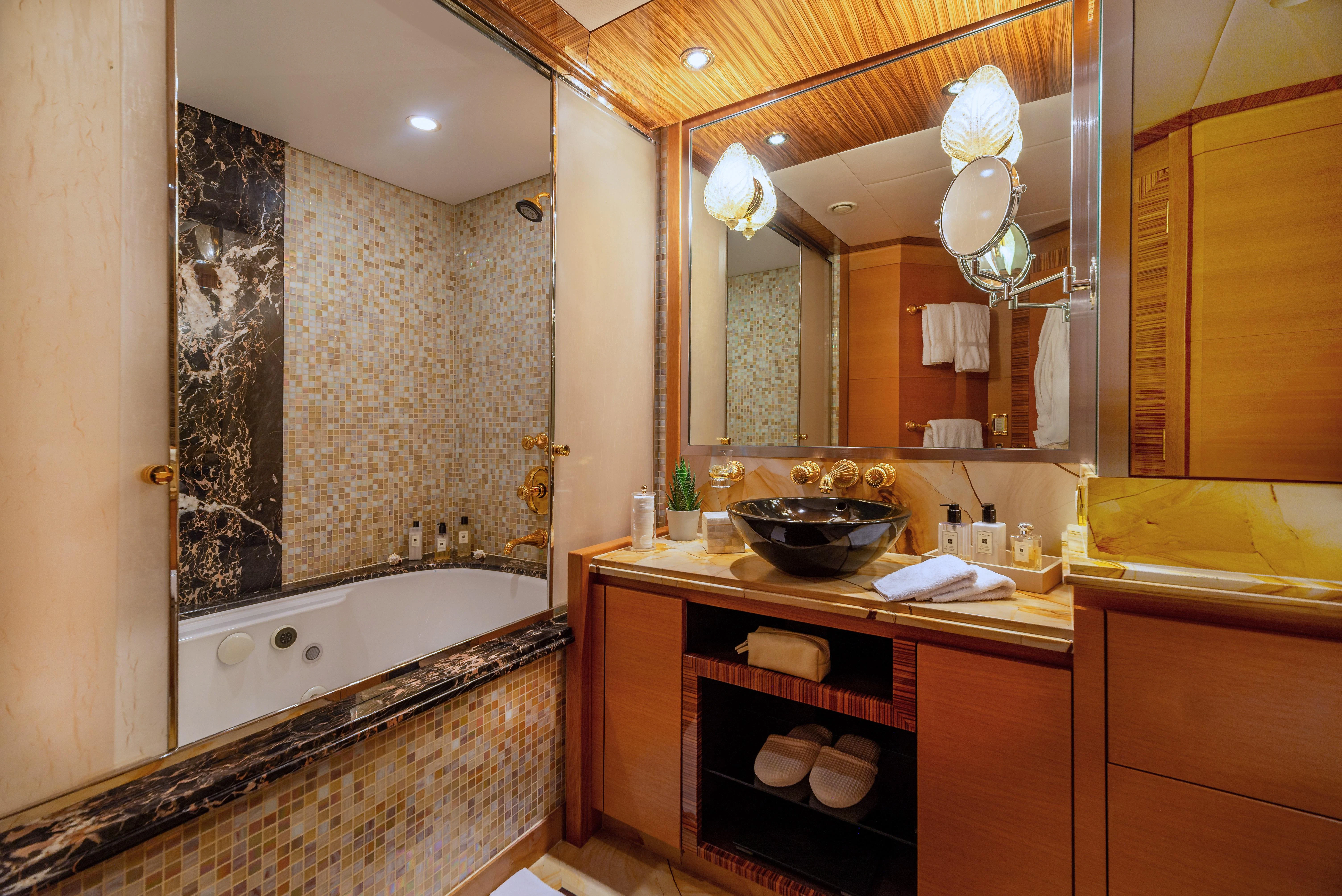 a bathroom with a large bathtub aboard HOKULANI Yacht for Sale
