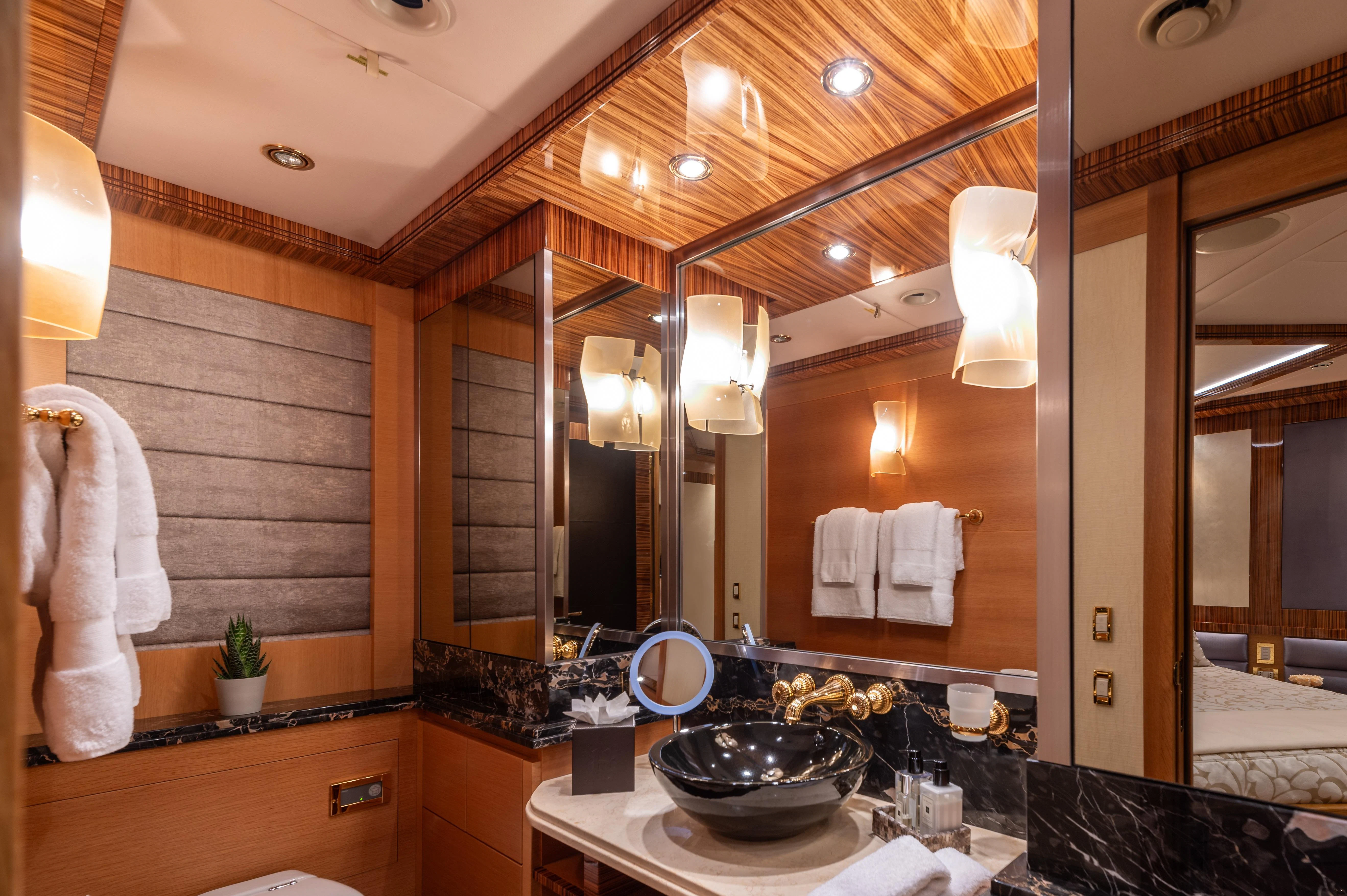 a bathroom with a large mirror aboard HOKULANI Yacht for Sale