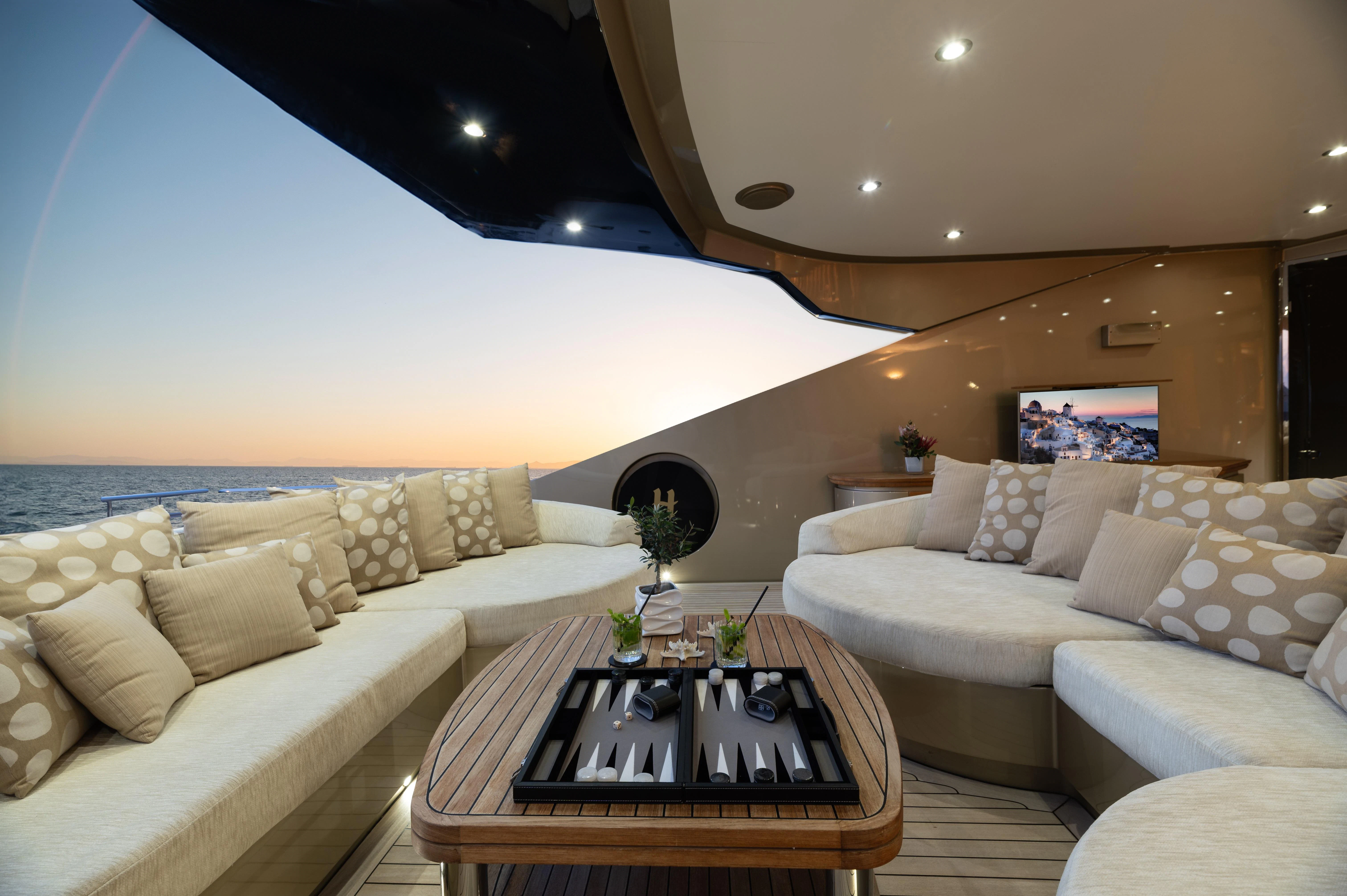 a living room with a large sofa and a table aboard HOKULANI Yacht for Sale