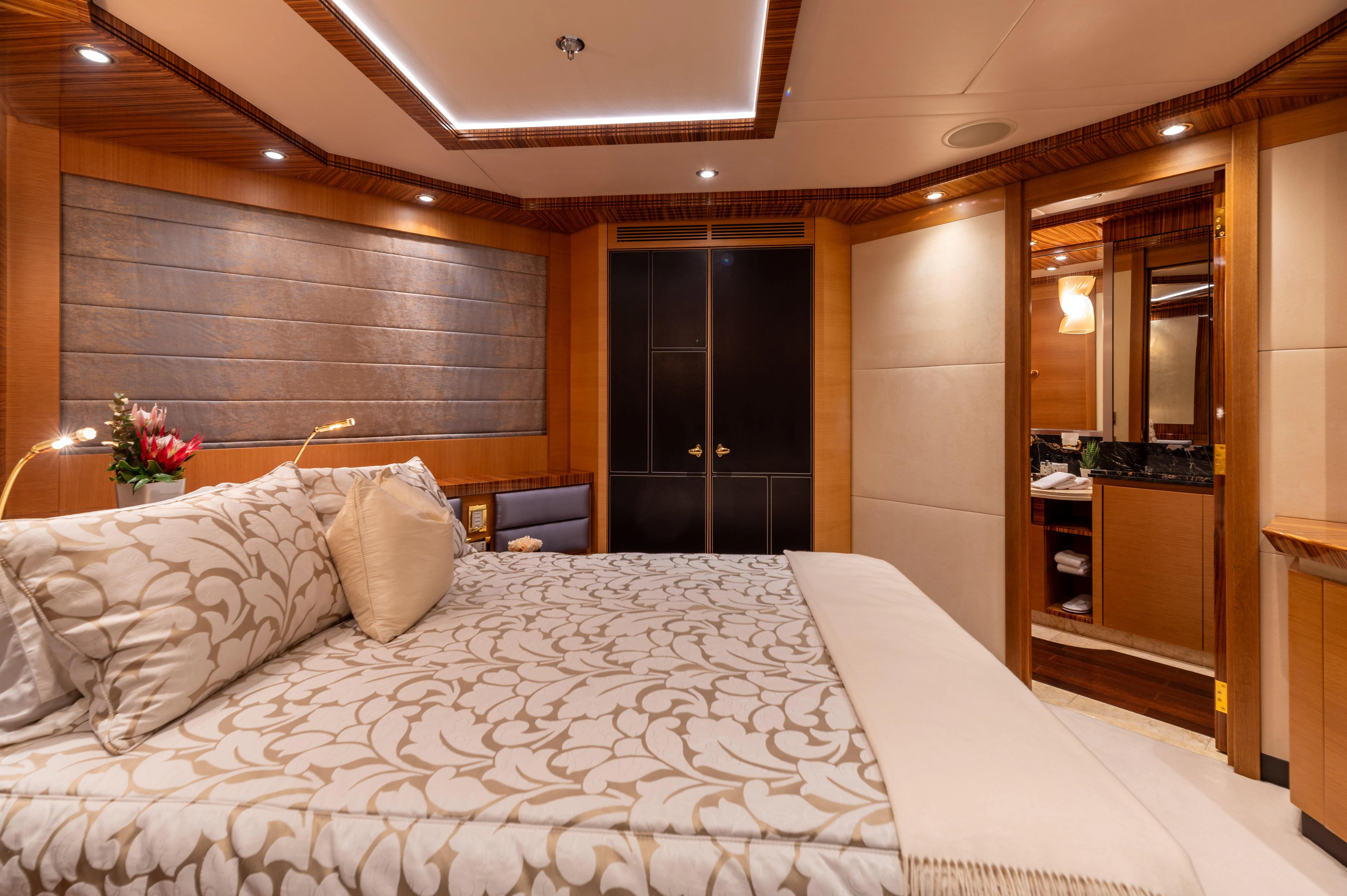 a bed with white sheets aboard HOKULANI Yacht for Sale