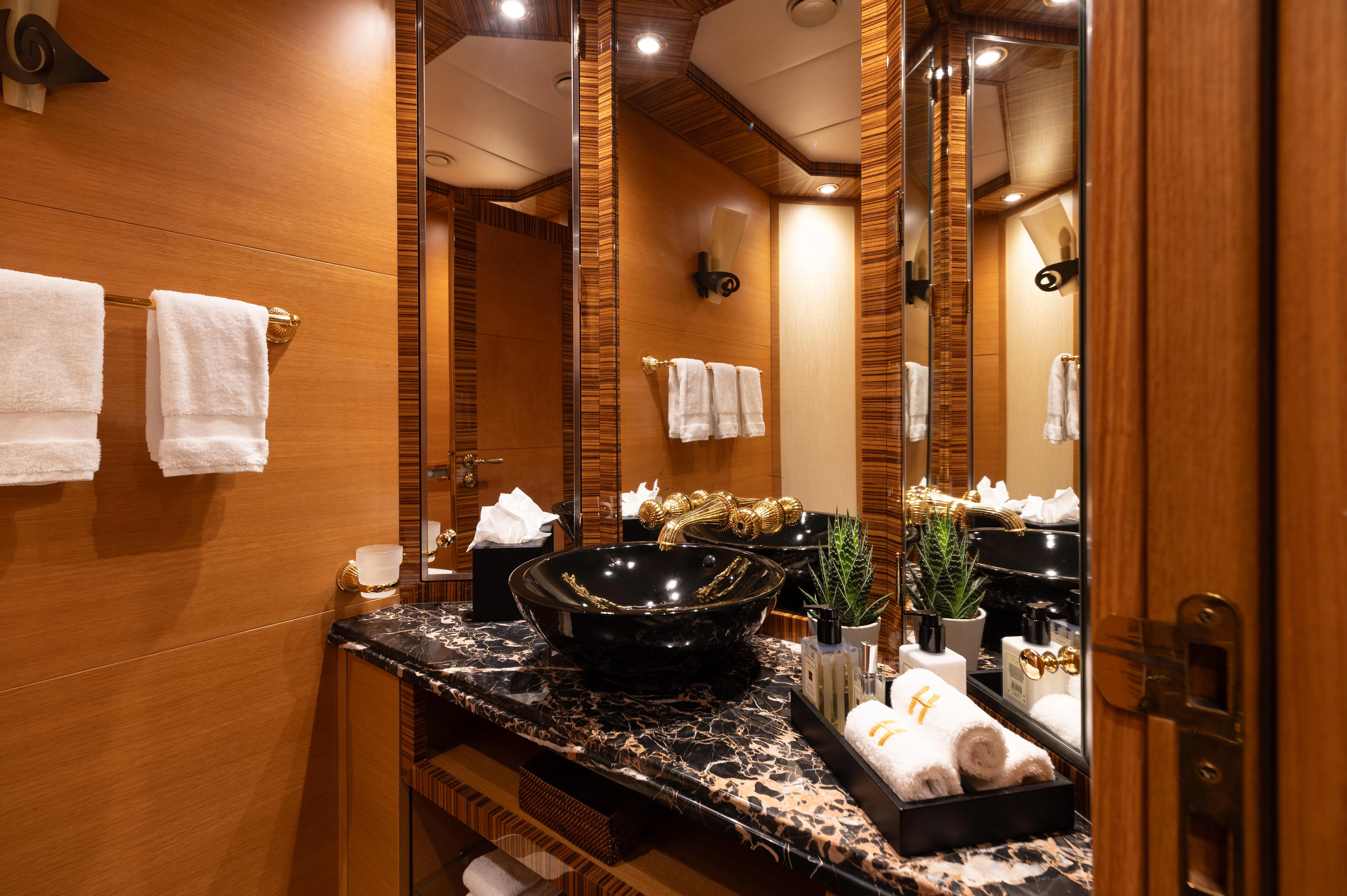 a bathroom with a large mirror aboard HOKULANI Yacht for Sale