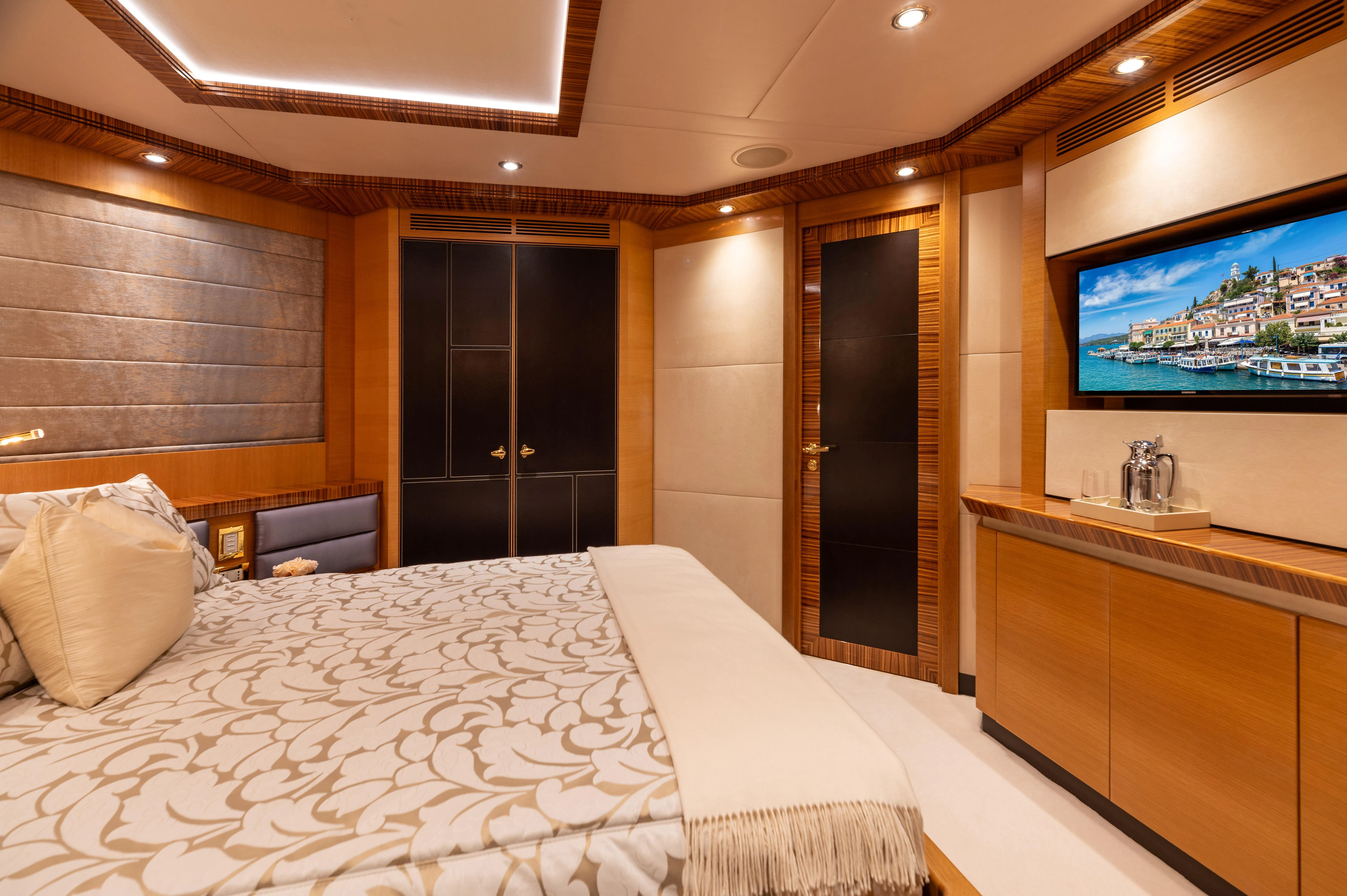 a hotel room with a bed and tv aboard HOKULANI Yacht for Sale