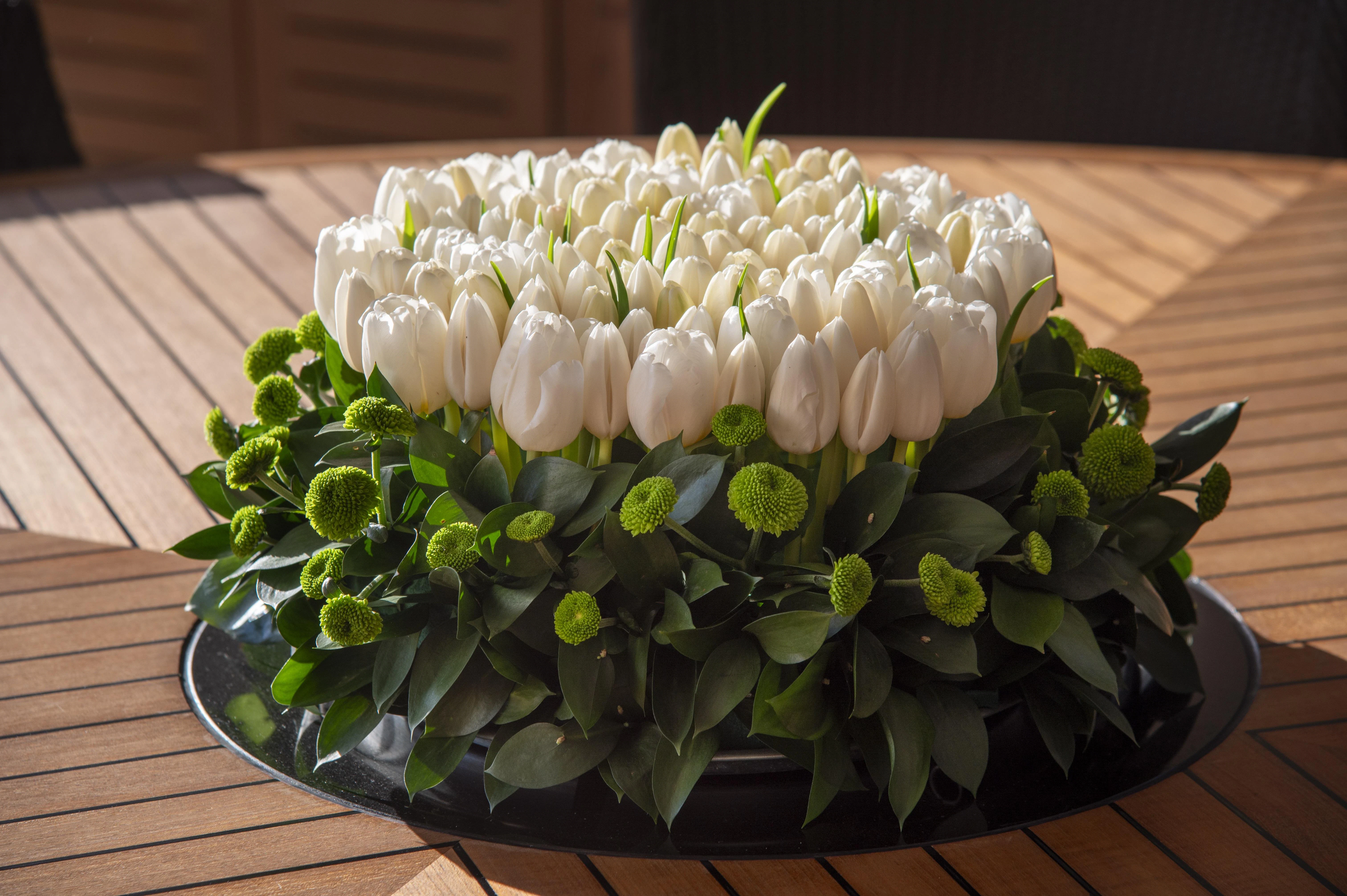 a cake with white flowers aboard HOKULANI Yacht for Sale