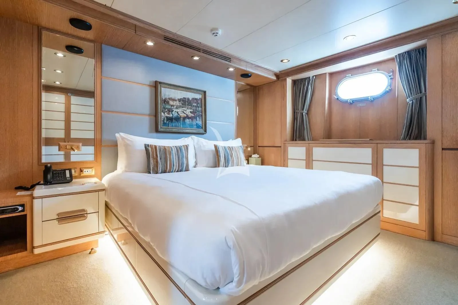 a room with a bed and a desk aboard TE MANU Yacht for Charter