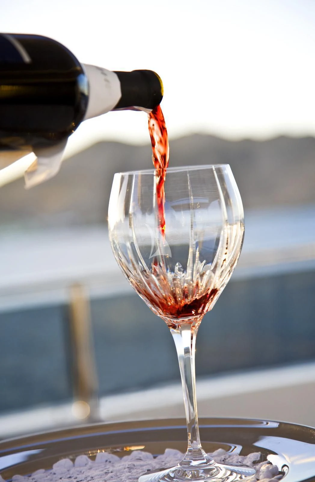 a wine glass with red liquid aboard TE MANU Yacht for Charter