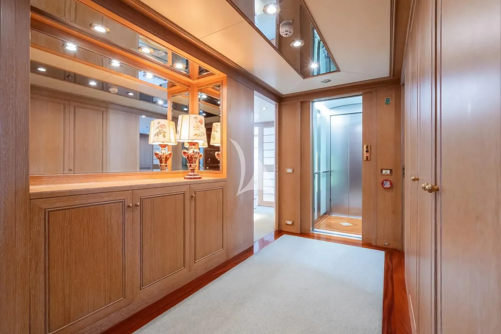 a room with a glass door and a desk with a glass of beer aboard TE MANU Yacht for Charter