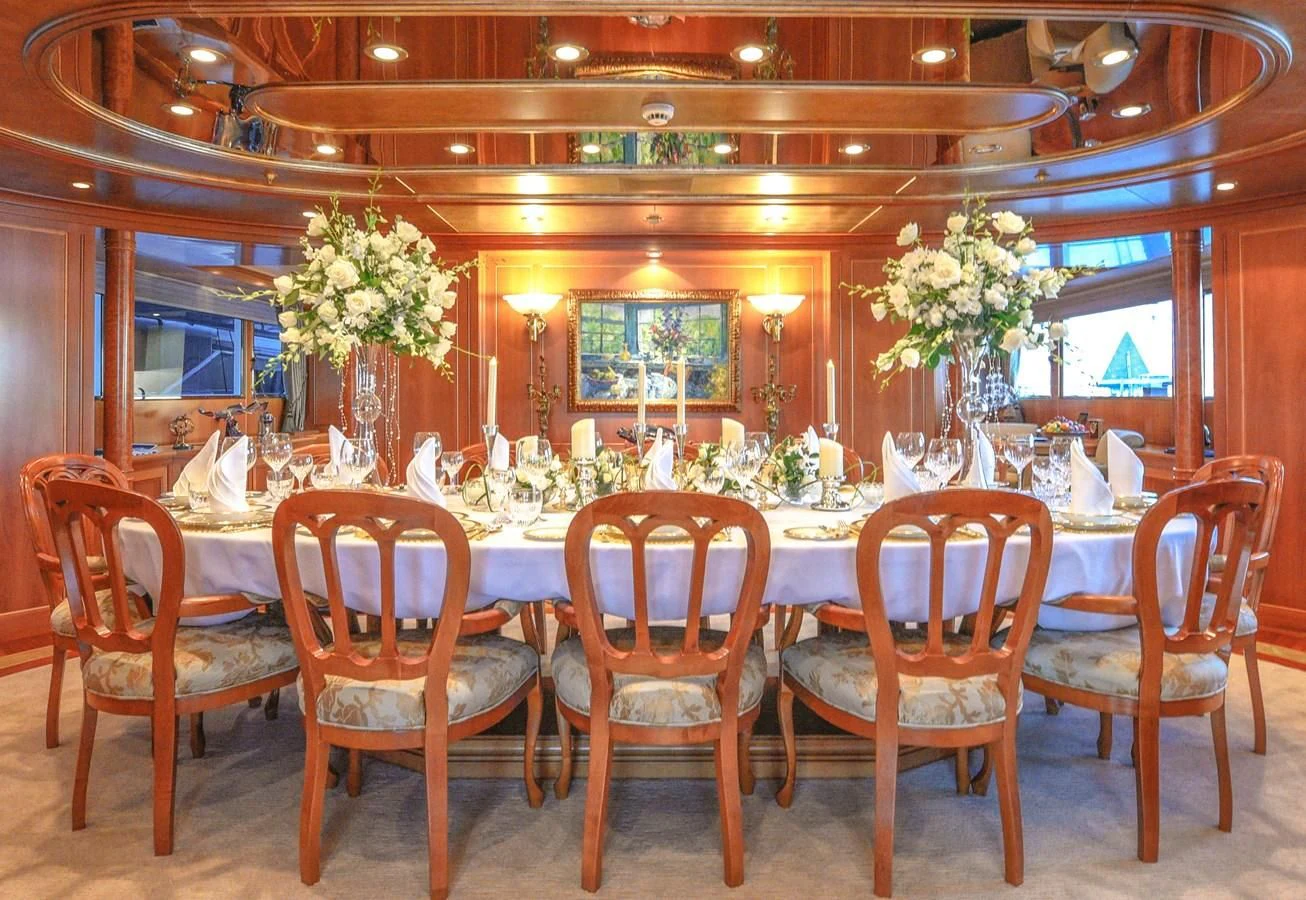 a large room with tables and chairs aboard TE MANU Yacht for Charter