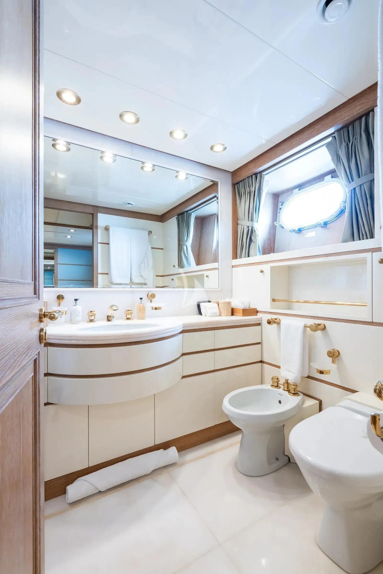 a bathroom with a large mirror aboard TE MANU Yacht for Charter