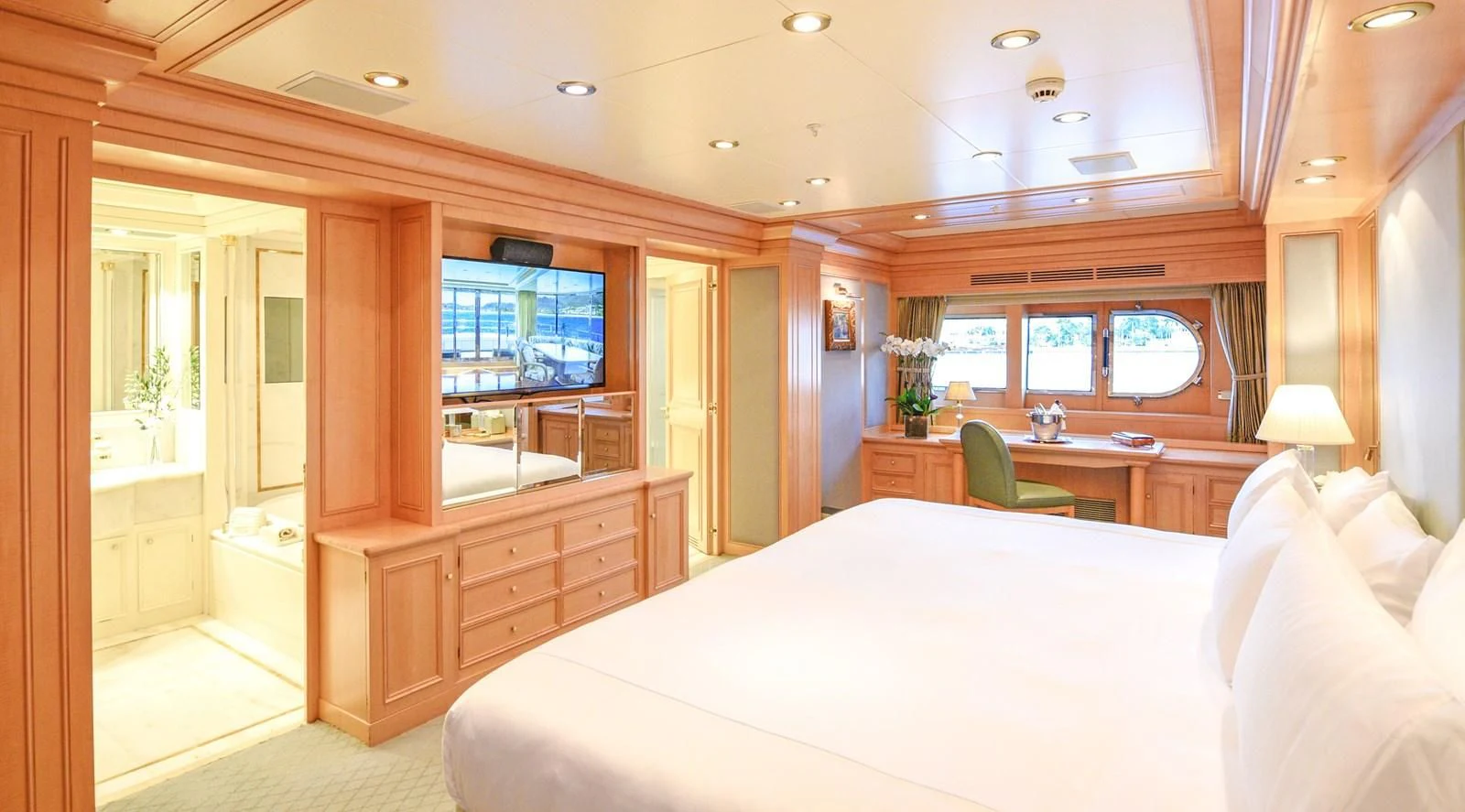 a bedroom with a bed and a desk aboard TE MANU Yacht for Charter