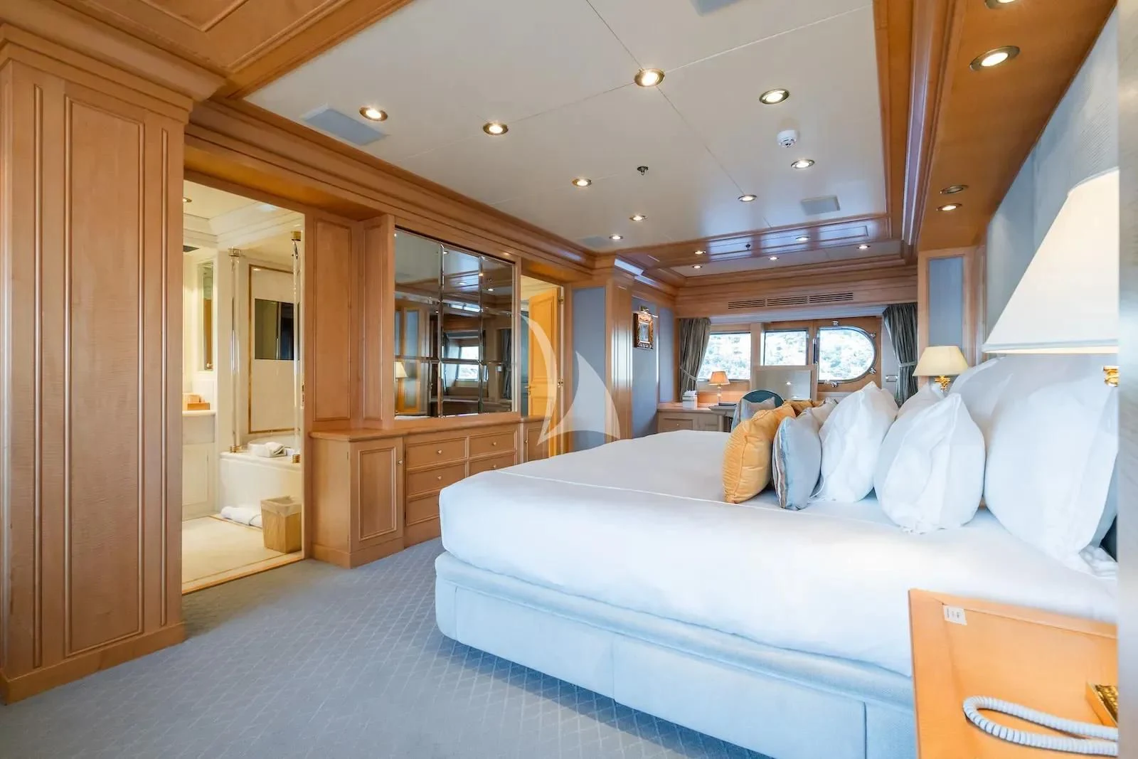a bedroom with a large bed aboard TE MANU Yacht for Charter