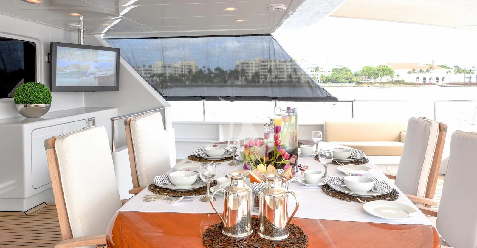 a table with plates and cups on it aboard TE MANU Yacht for Charter