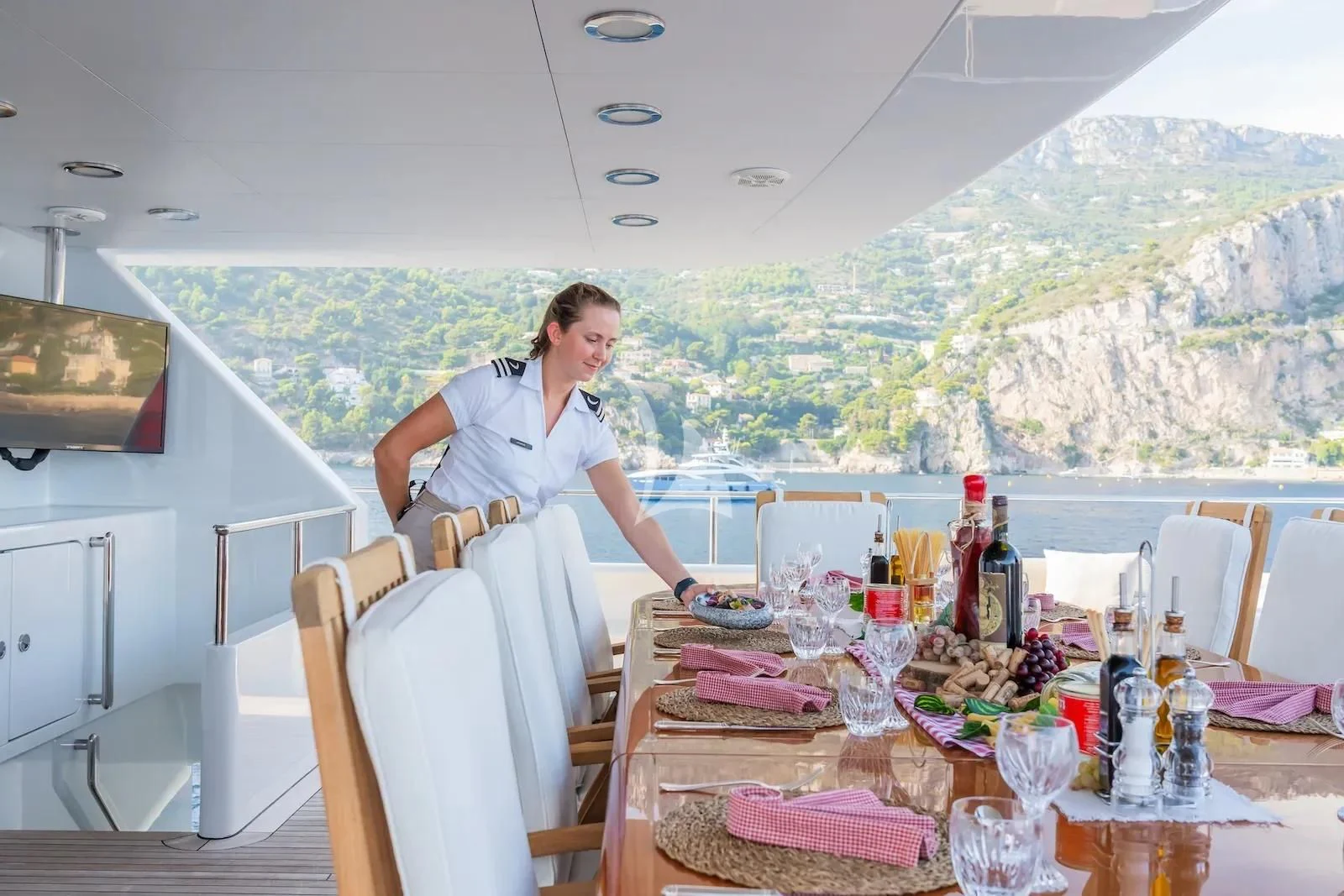 a person cooking on a table aboard TE MANU Yacht for Charter