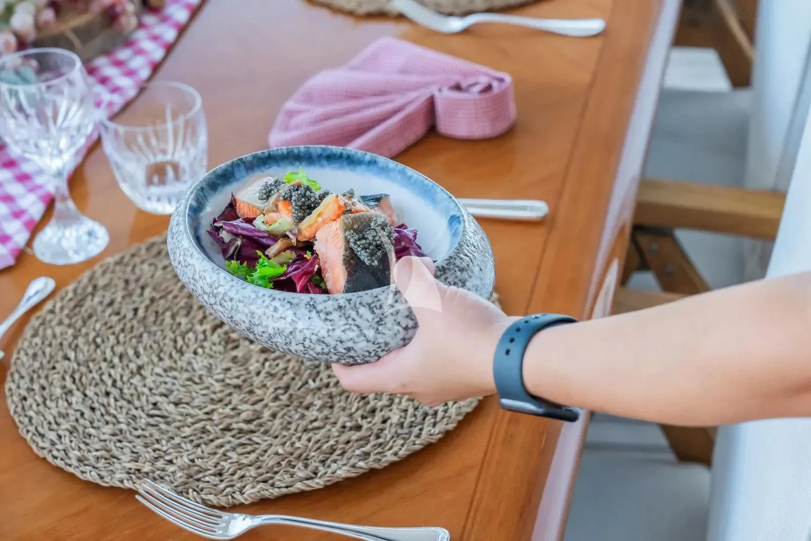 a person holding a bowl of food aboard TE MANU Yacht for Charter