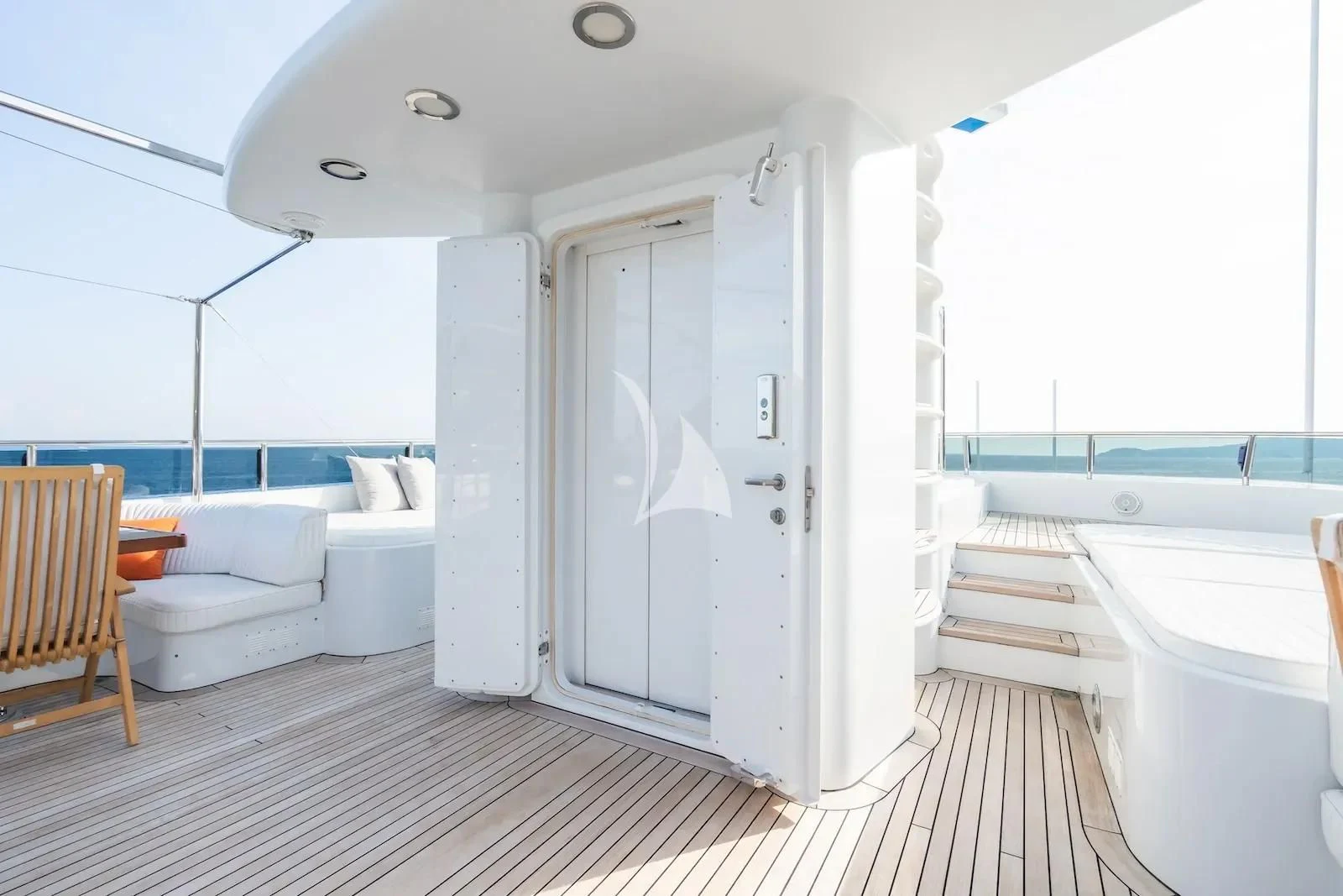 a white bathroom with a tub and a wooden chair aboard TE MANU Yacht for Charter