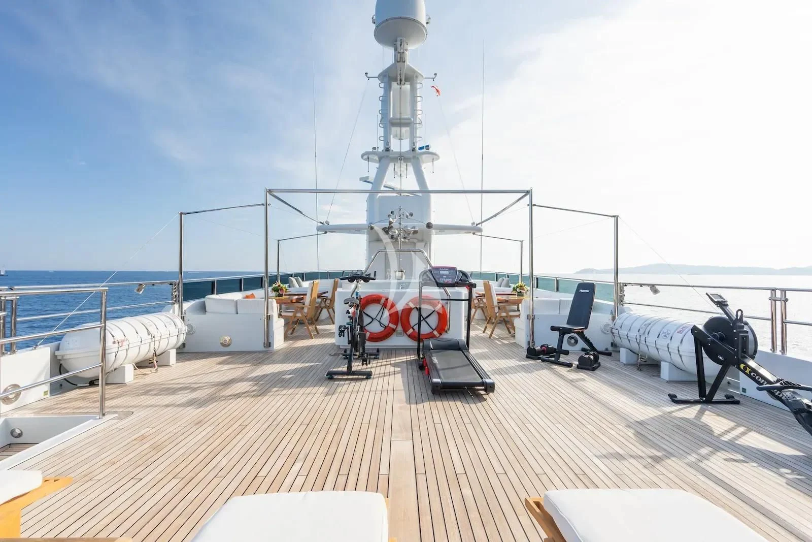 a deck with a deck and a large white tower with a white railing and a white table and aboard TE MANU Yacht for Charter