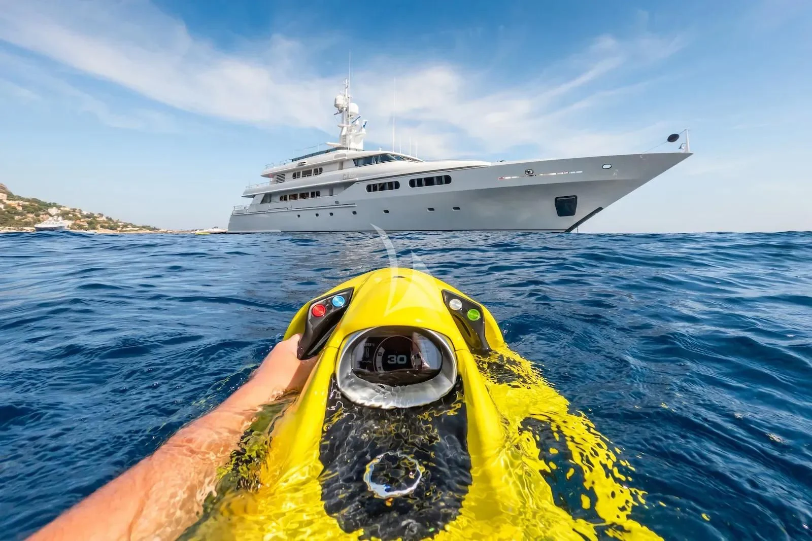 a person in a yellow kayak in front of a white ship aboard TE MANU Yacht for Charter