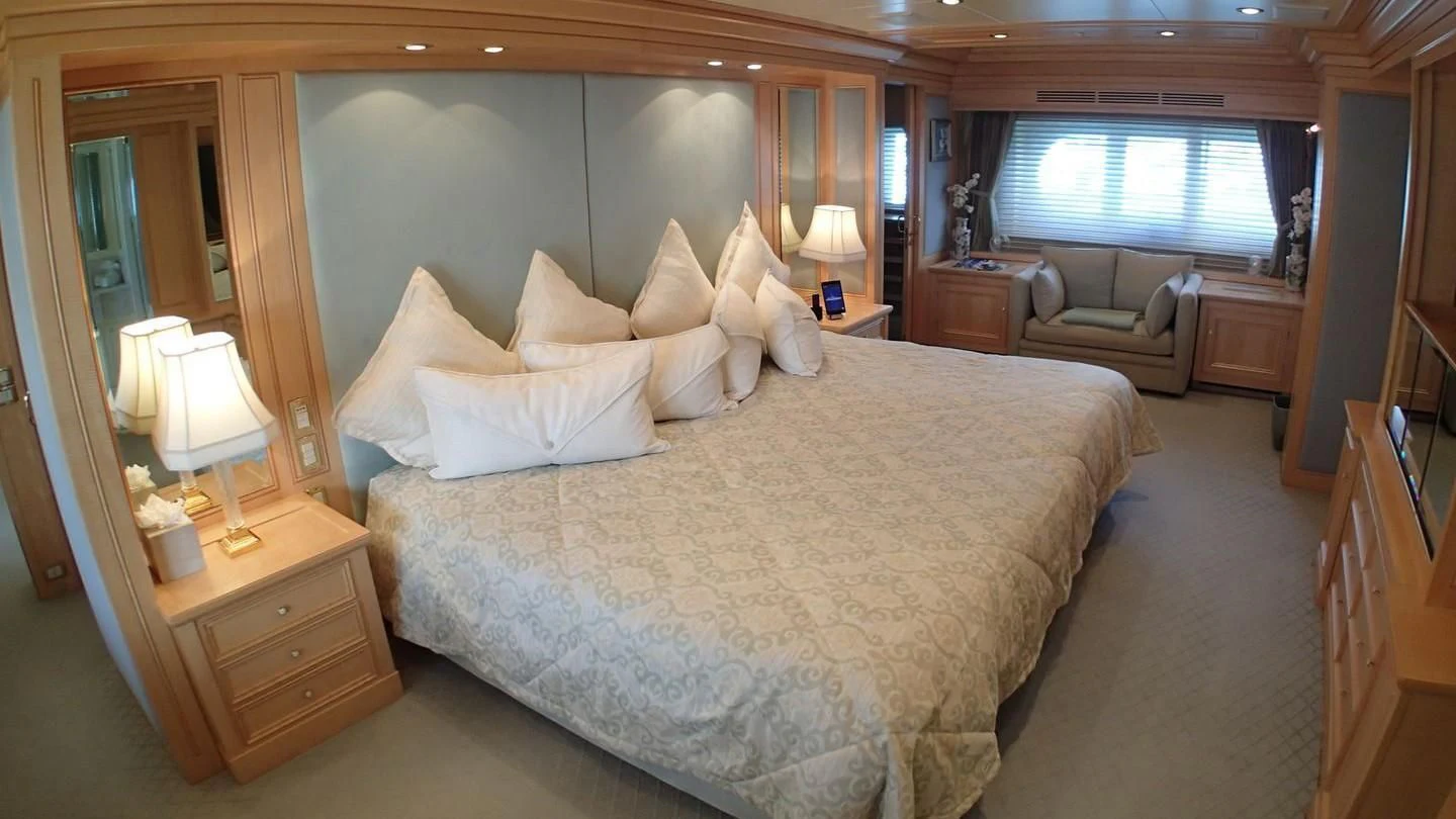 a large bed in a hotel room aboard TE MANU Yacht for Charter