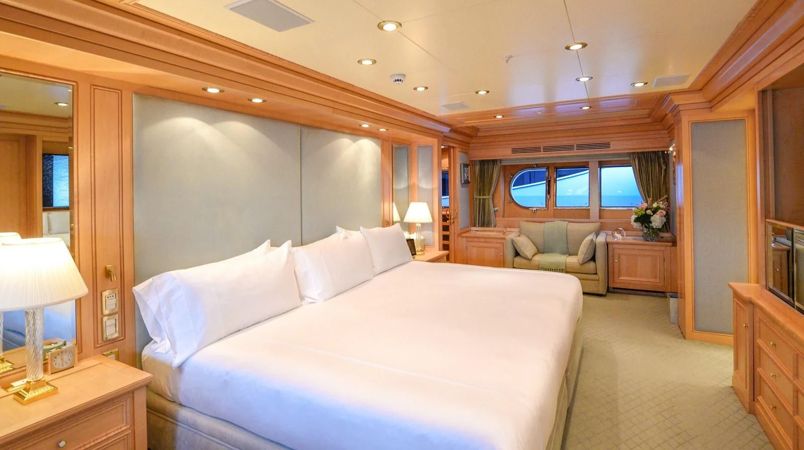a large bedroom with a bed and a couch aboard TE MANU Yacht for Charter