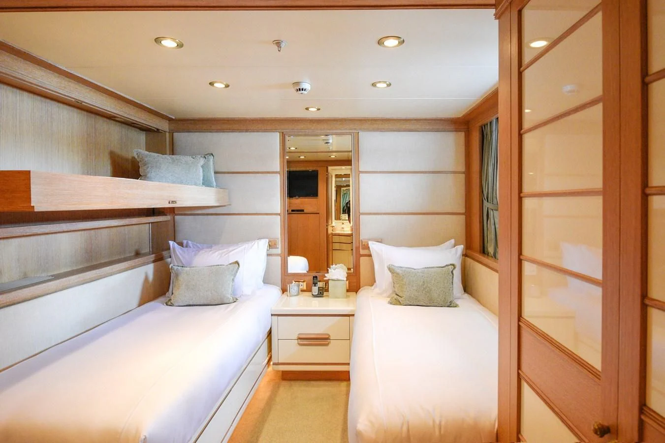 a room with a bed and a mirror aboard TE MANU Yacht for Charter