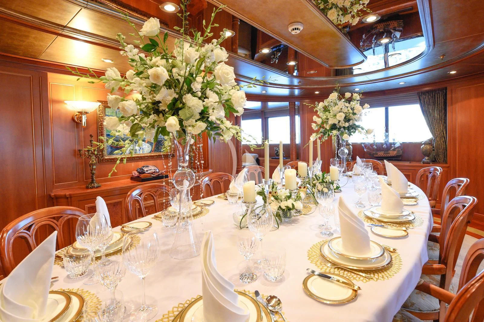 a table set with white flowers aboard TE MANU Yacht for Charter