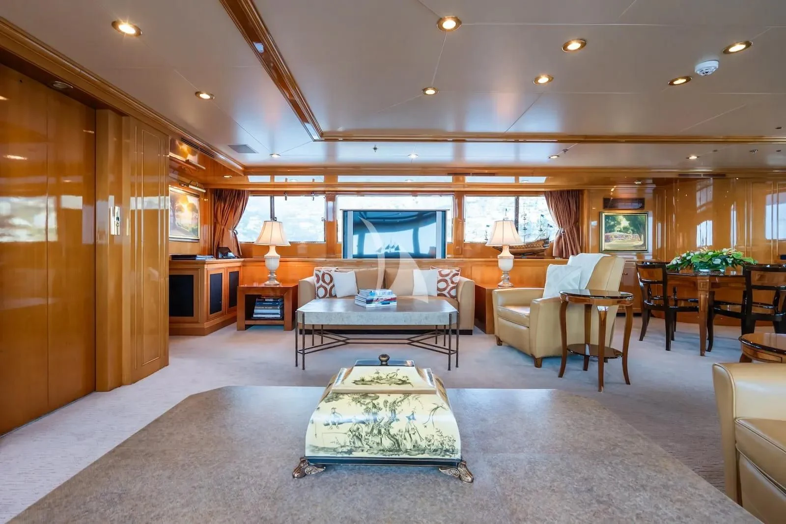 a large living room with a table and chairs aboard TE MANU Yacht for Charter