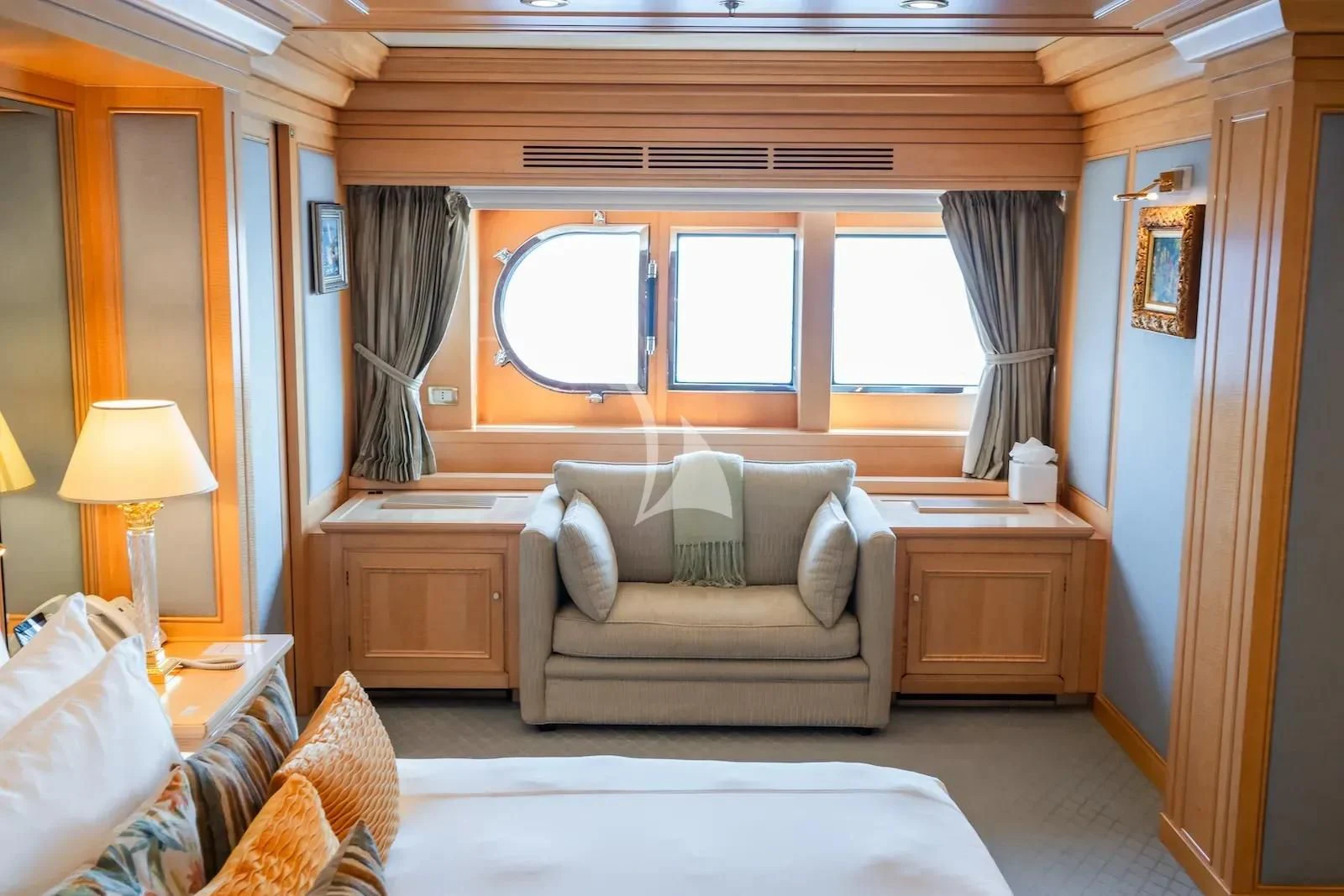 a living room with a couch and a window aboard TE MANU Yacht for Charter