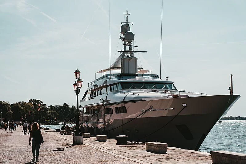 a large ship docked at a pier aboard TE MANU Yacht for Charter