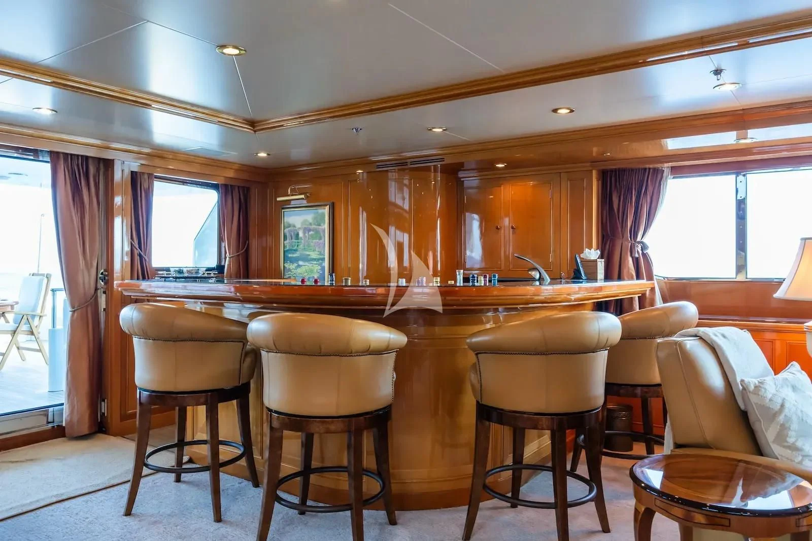 a kitchen with a bar and chairs aboard TE MANU Yacht for Charter