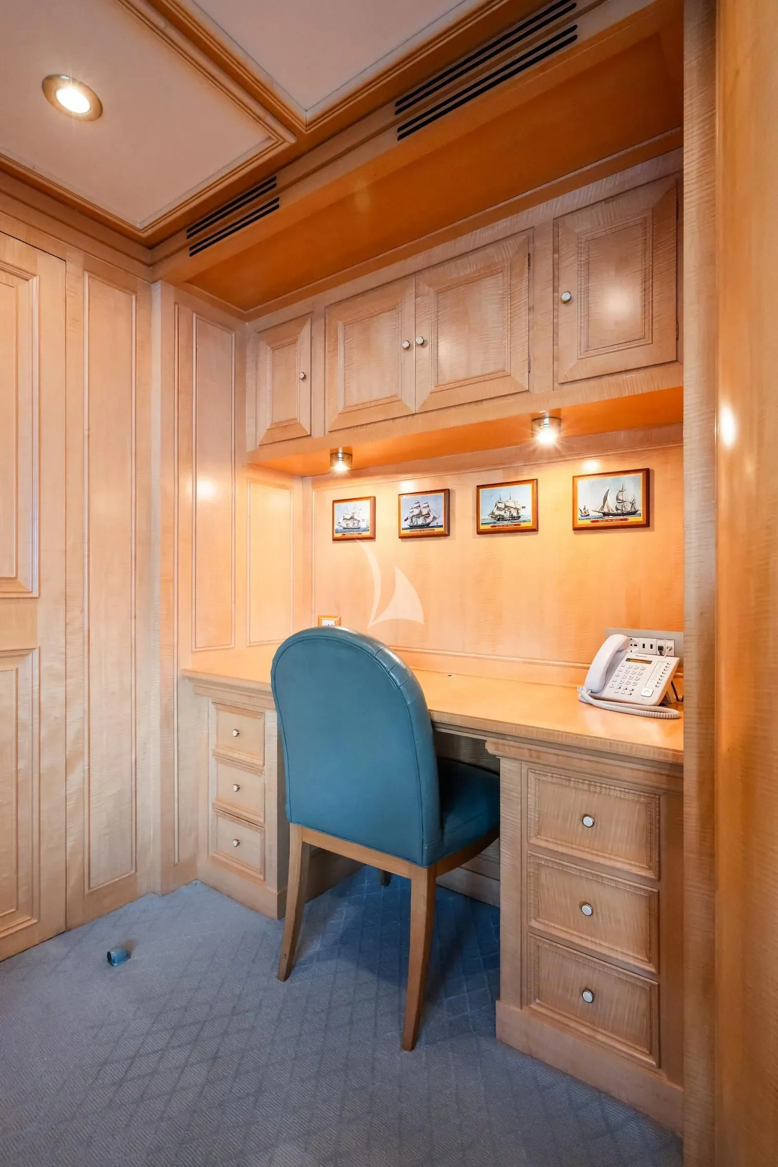 a chair and a desk in a room aboard TE MANU Yacht for Charter