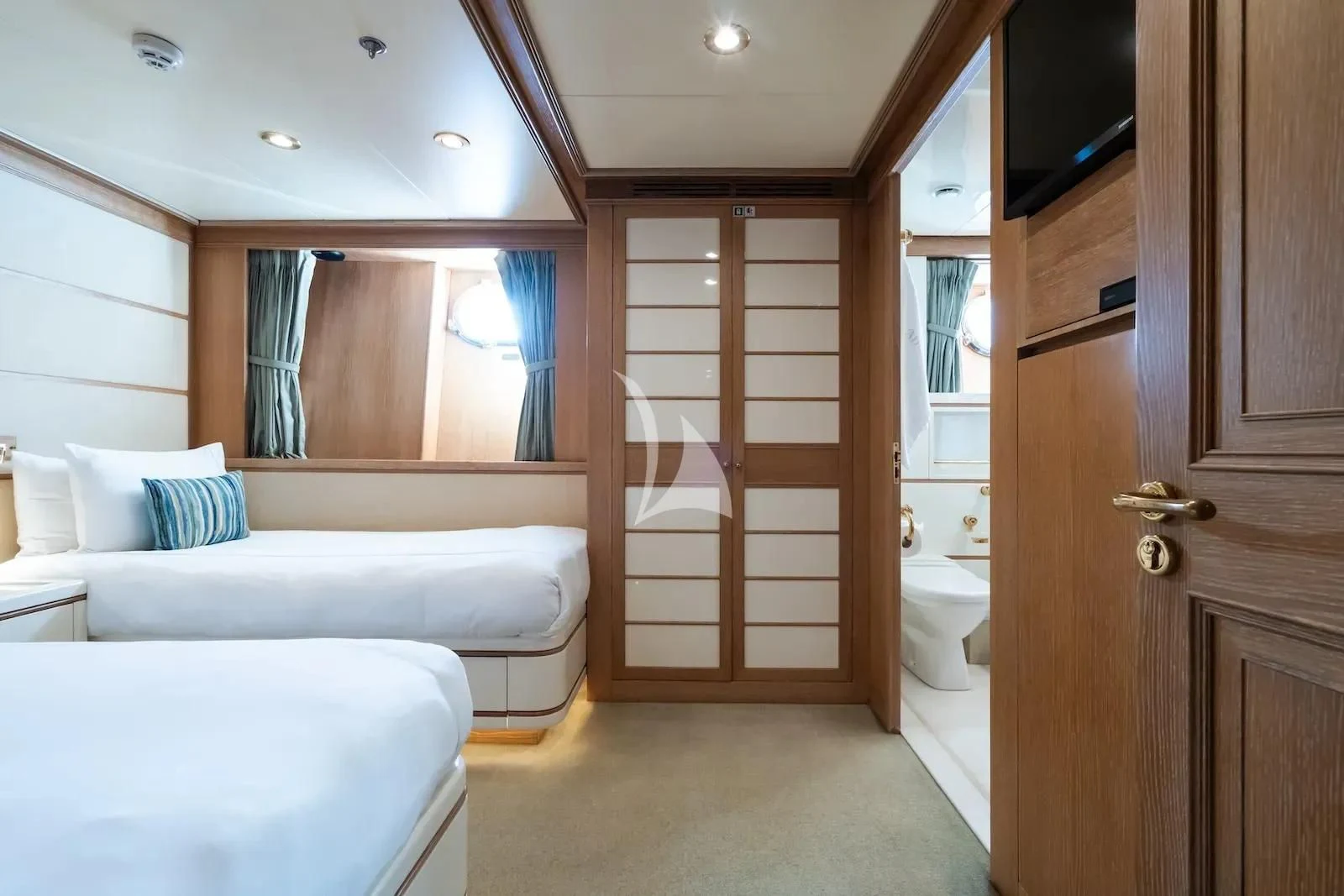 a bedroom with a bed and a closet aboard TE MANU Yacht for Charter
