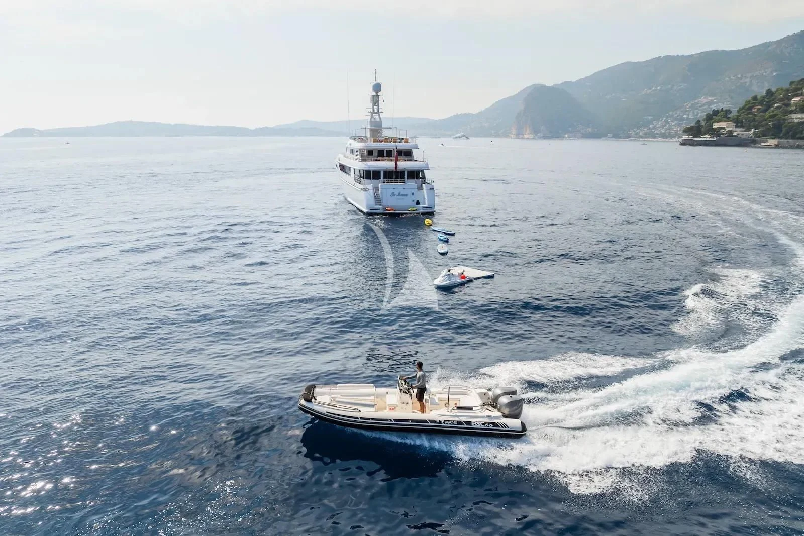 a boat and a couple of people on a boat in the water aboard TE MANU Yacht for Charter